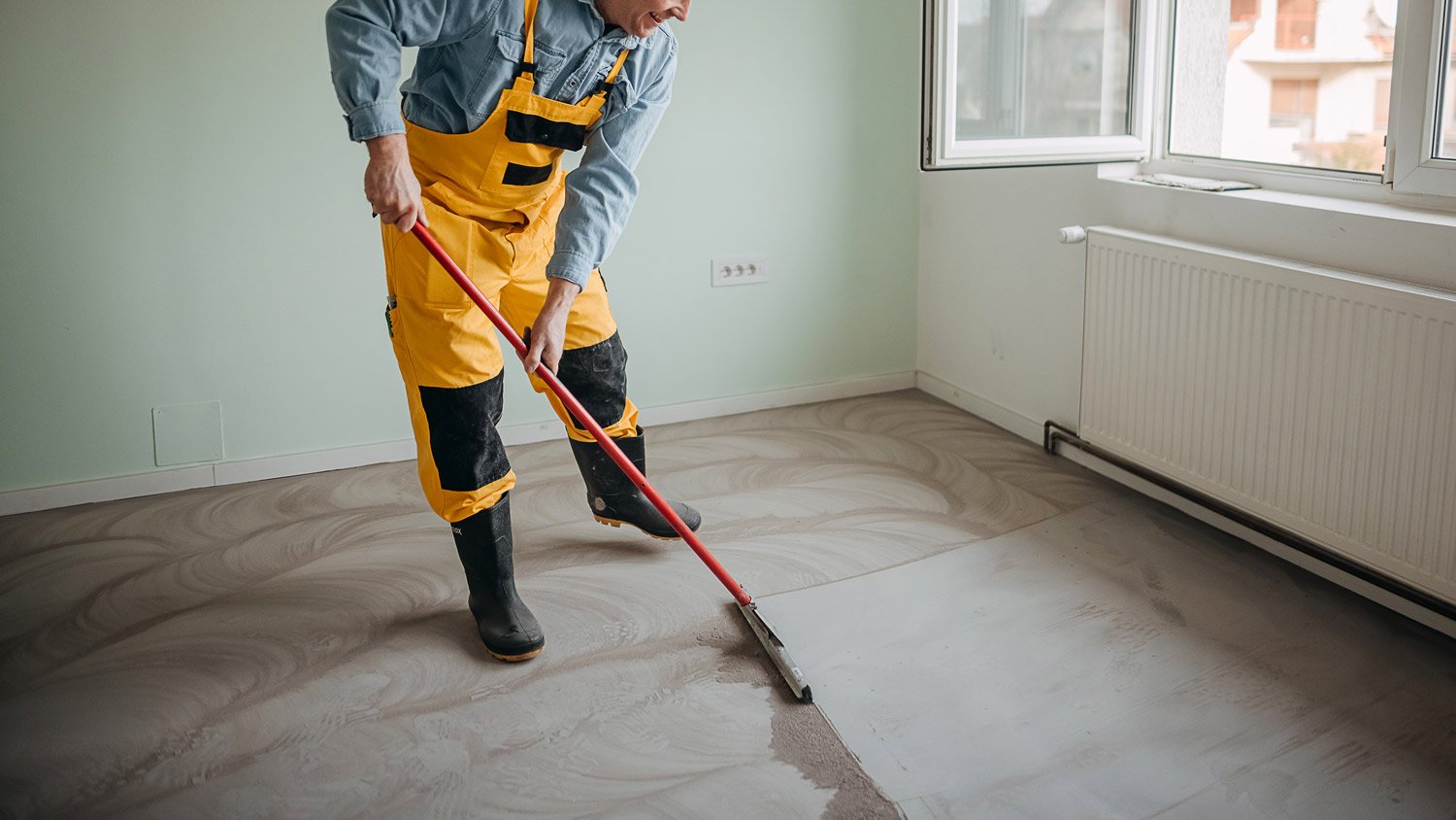 Man with a squeegee on the floor