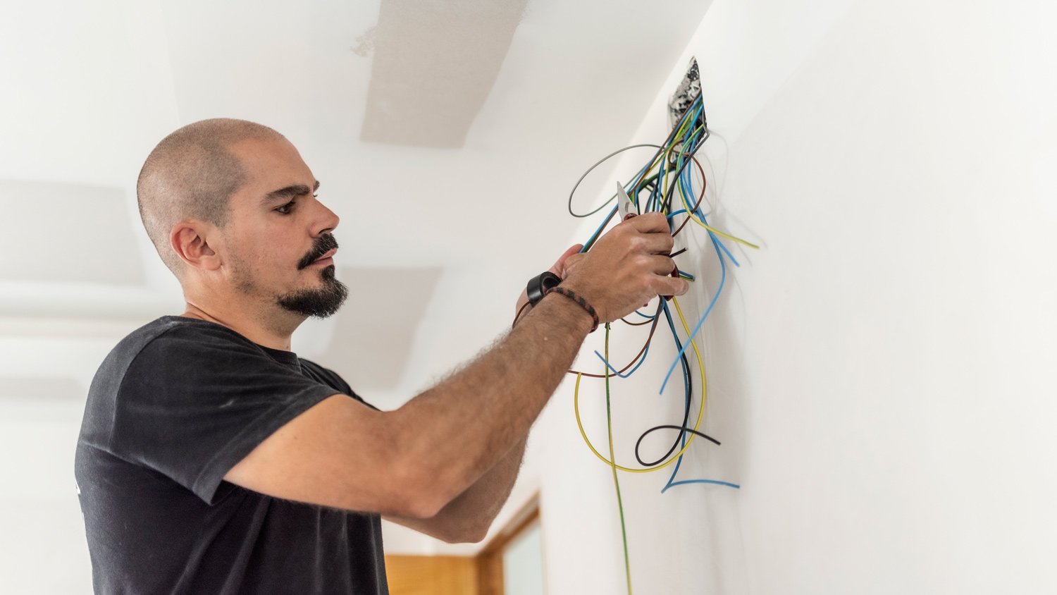 Electrician places electrical circuit and cables in an electricity box
