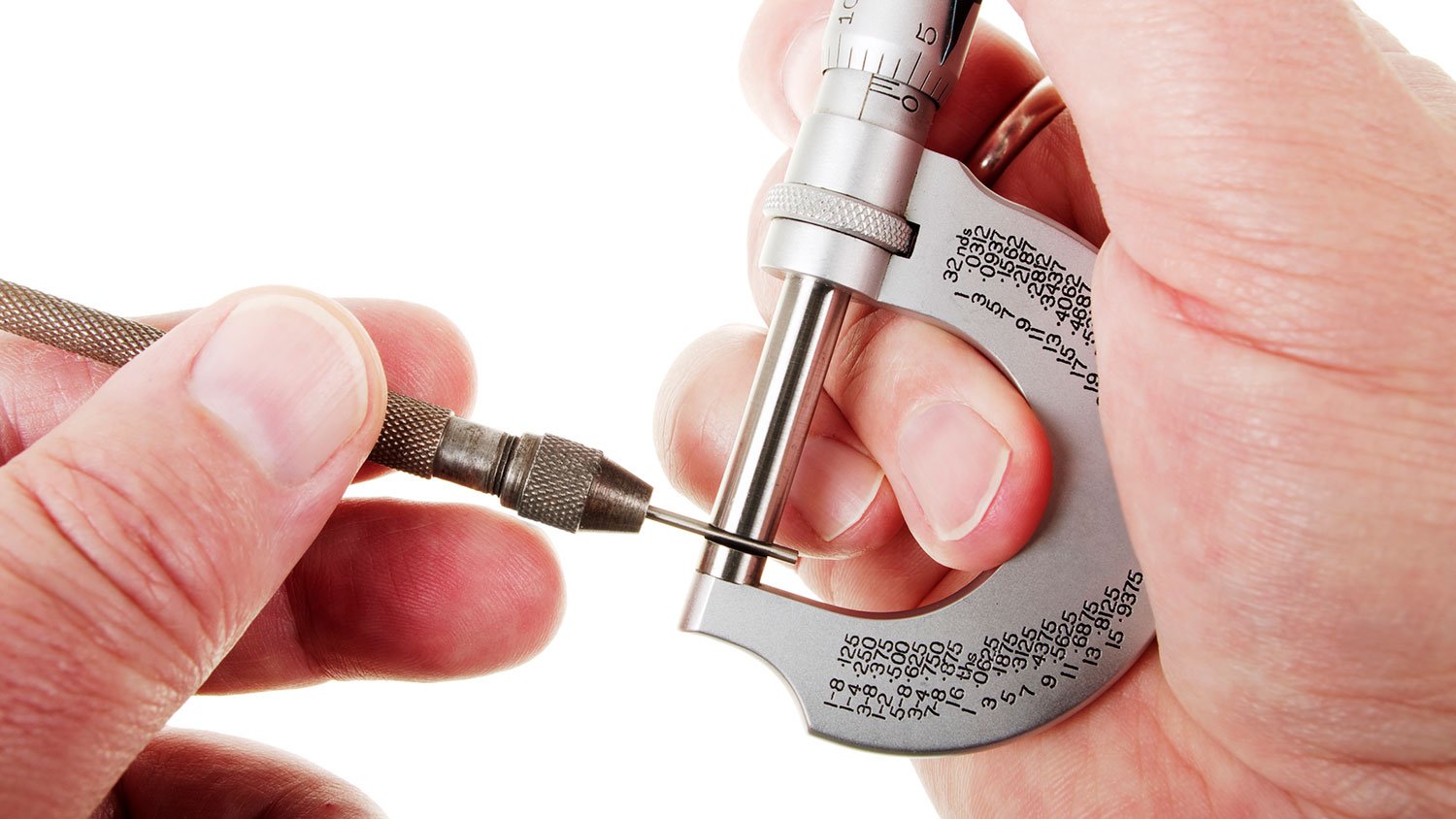 Closeup of a person using a micrometer to measure a round bar