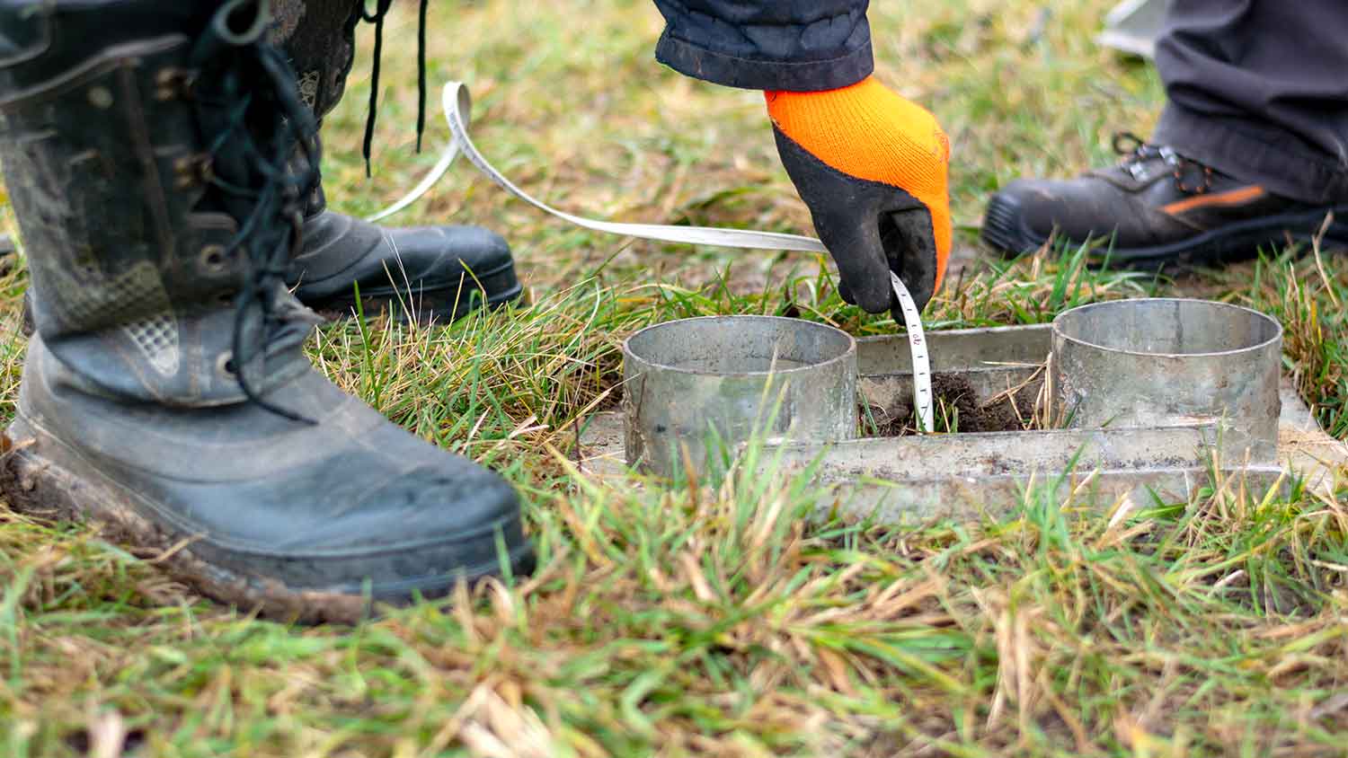 Well inspector measuring water levels in a well