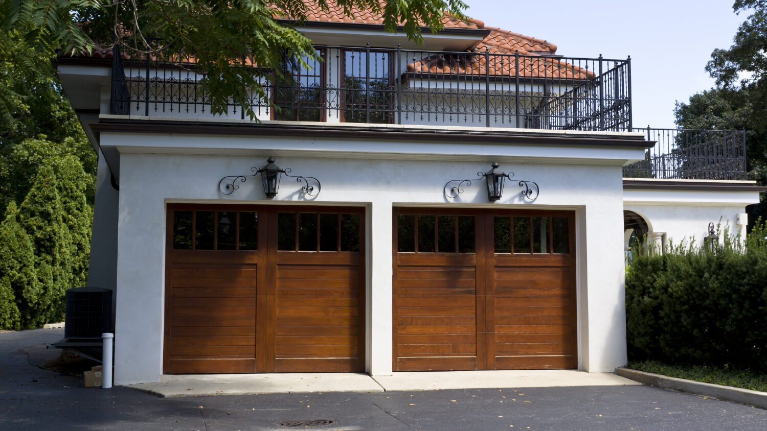 wooden garage doors on White House with iron accents 