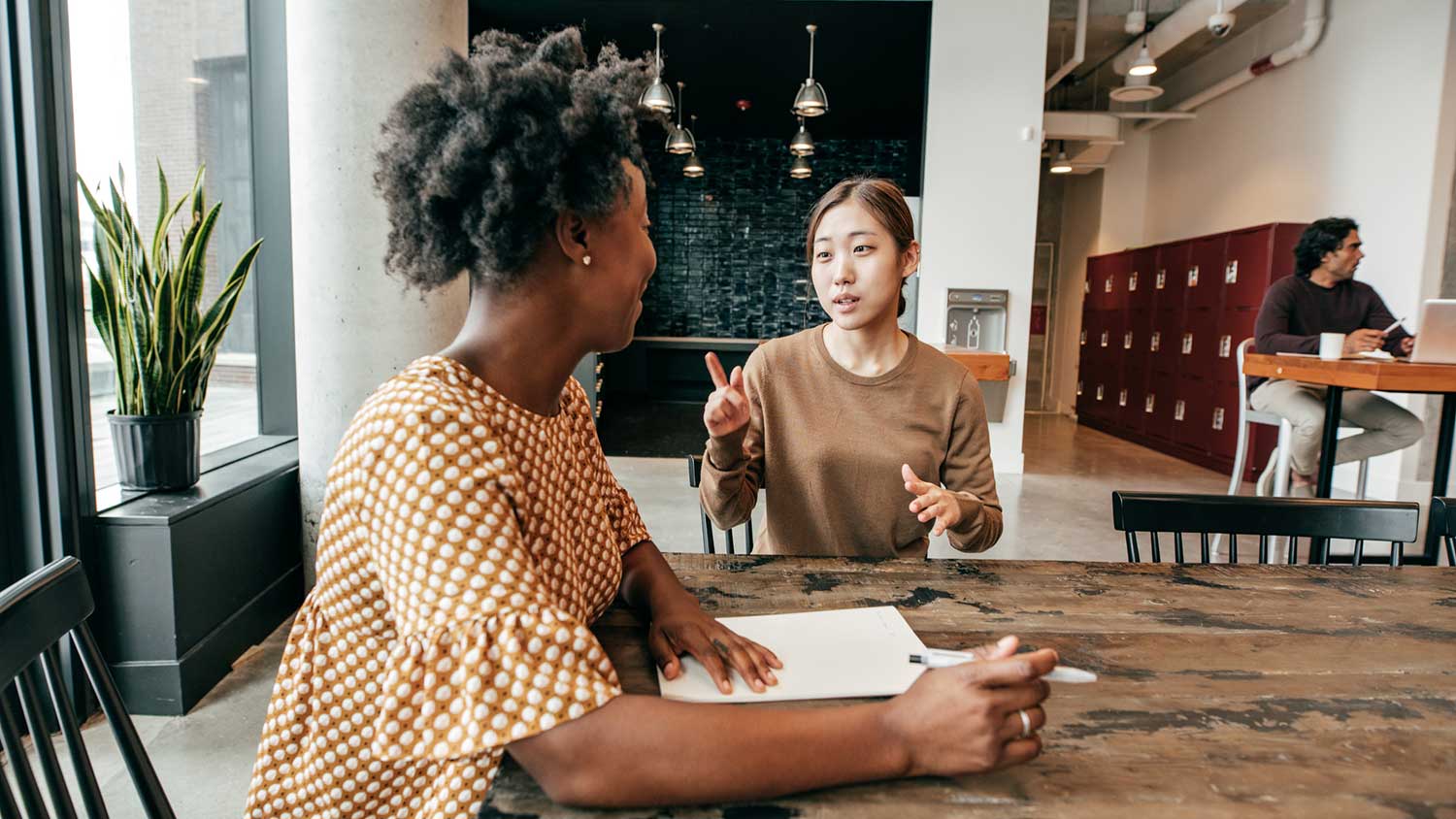 Young woman talking with real estate agent at the office