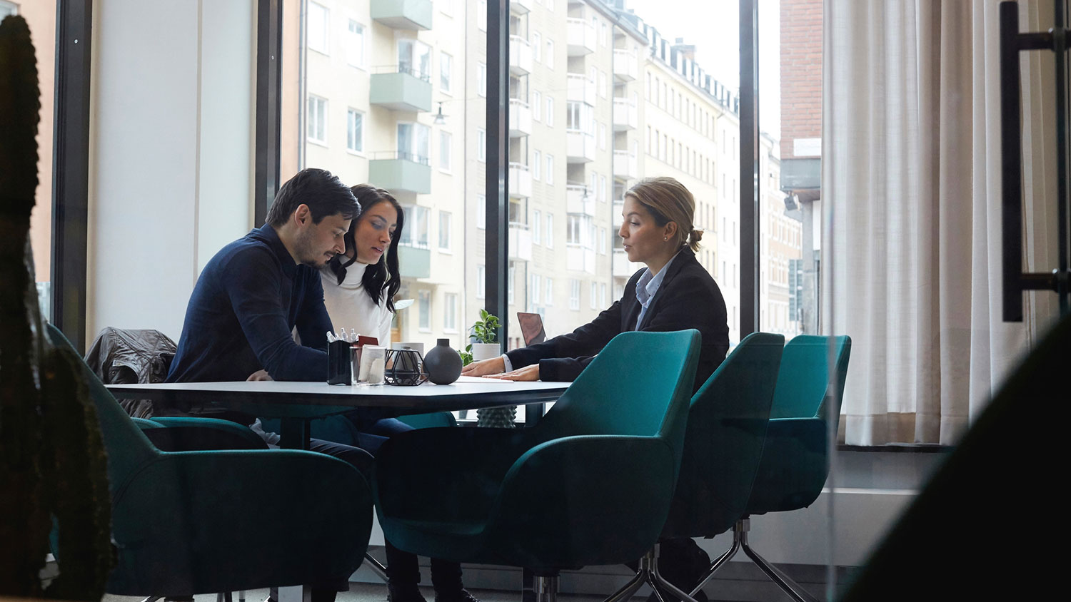 Couple meeting with real estate agent at the office