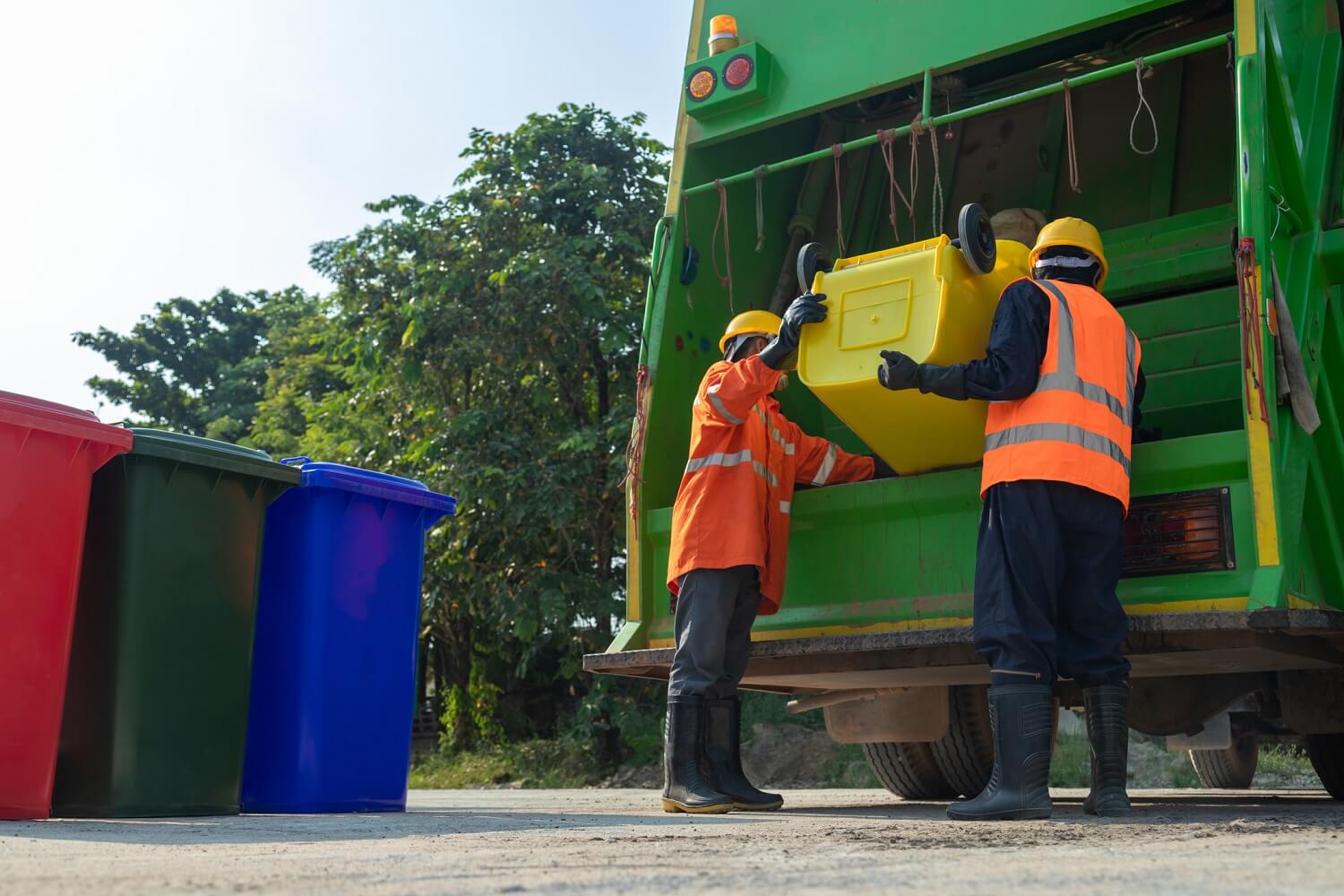 Two workers of a garbage collector truck