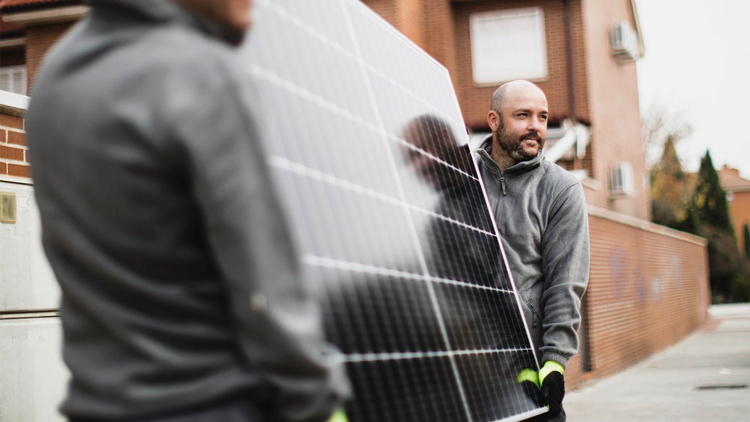 Construction worker installing solar panels