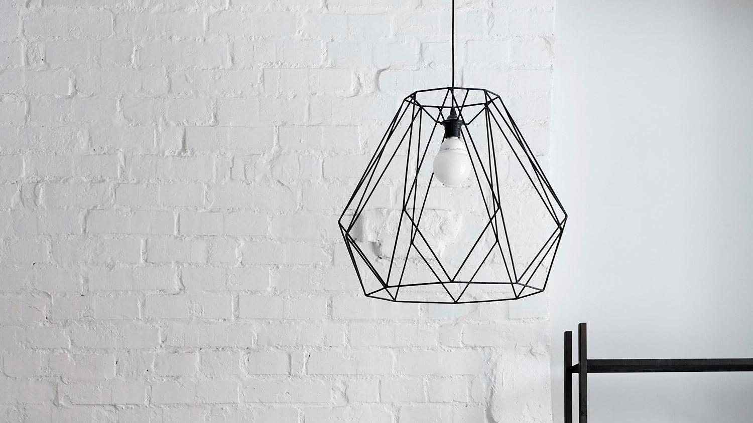 White and black domestic kitchen with metal light