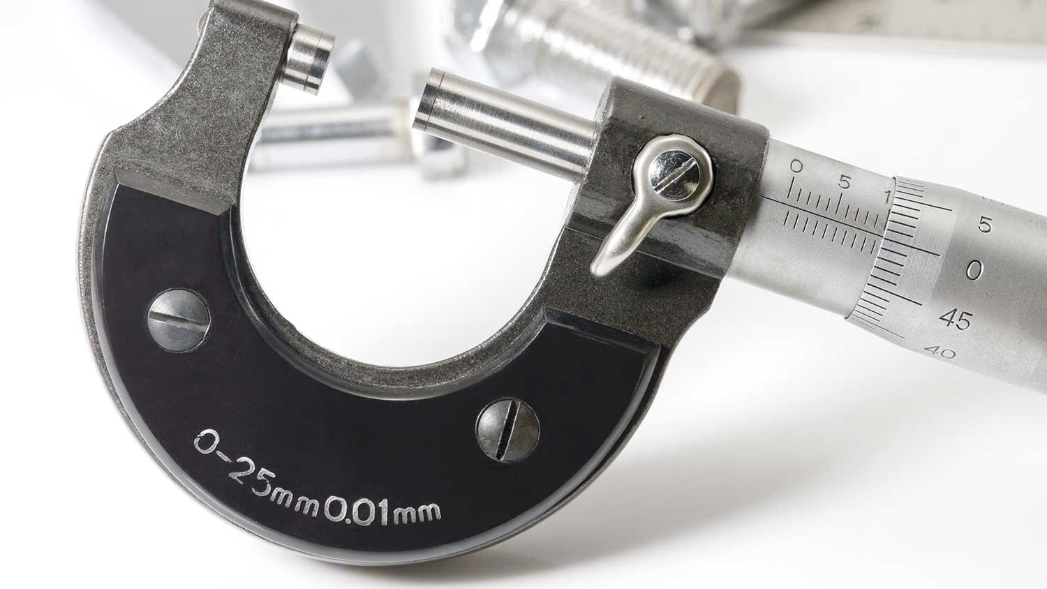 Closeup of a metric micrometer on a white table