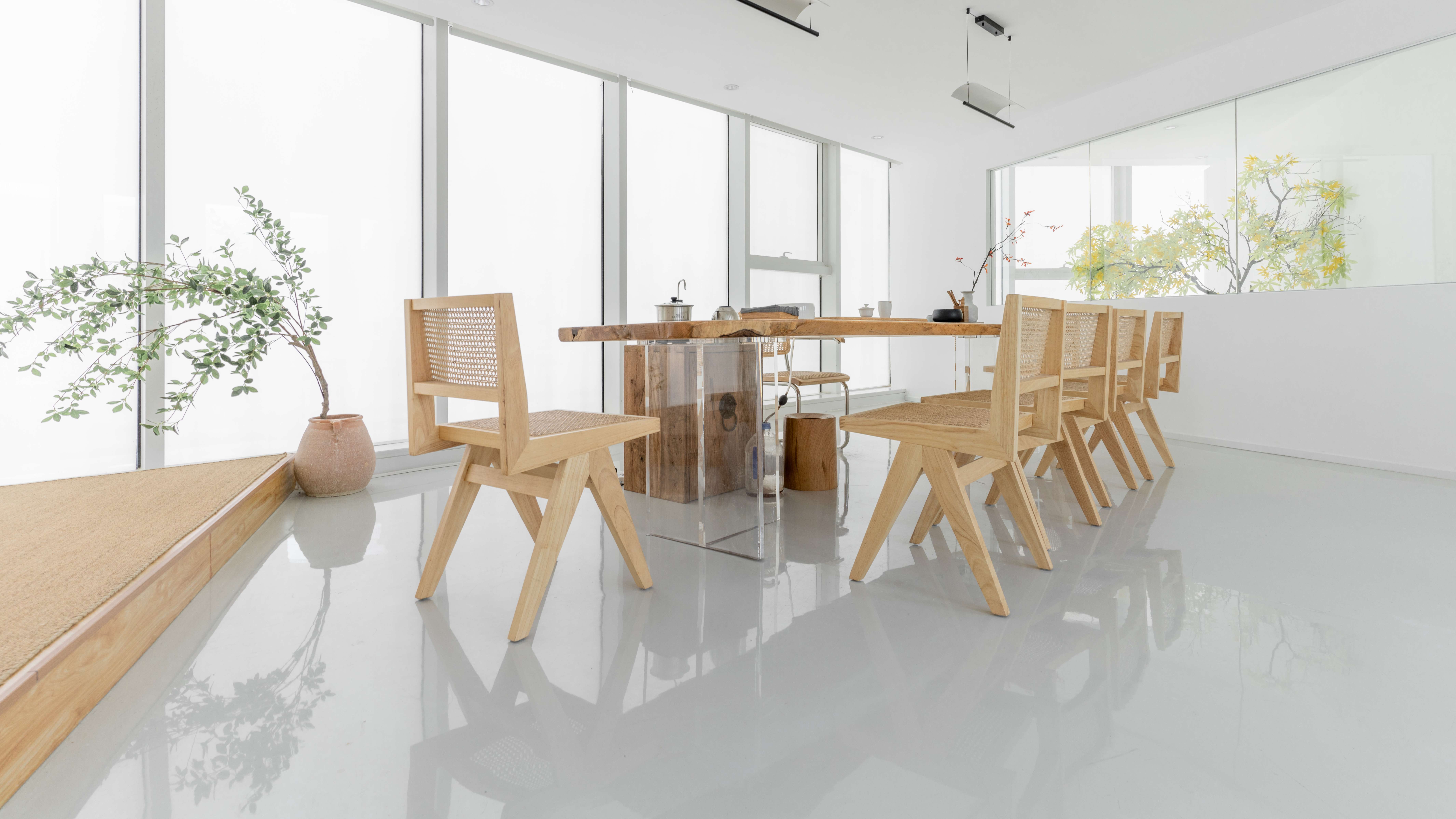 Bright minimalist dining area with epoxy floor