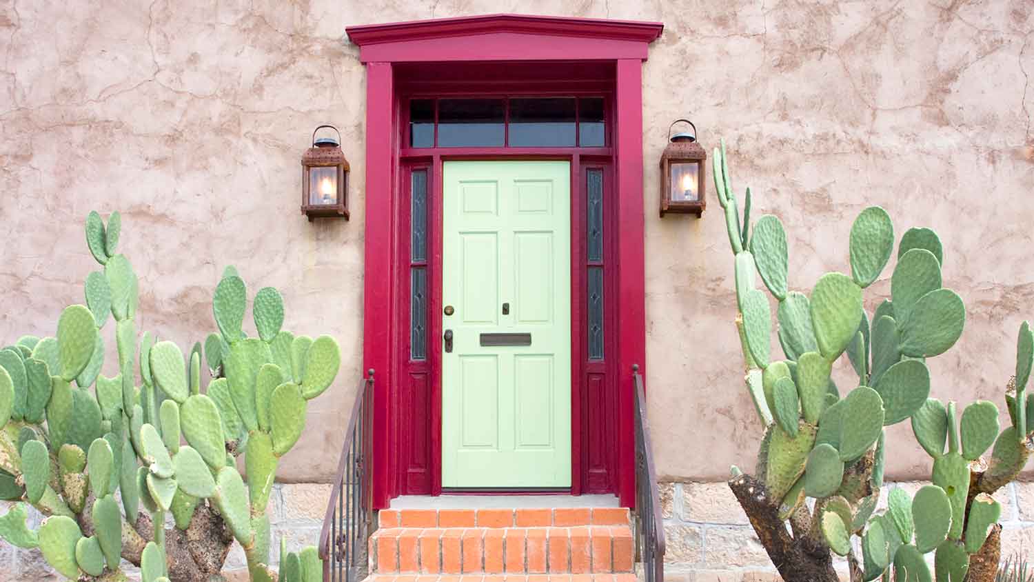 House with cactus and mint green front door