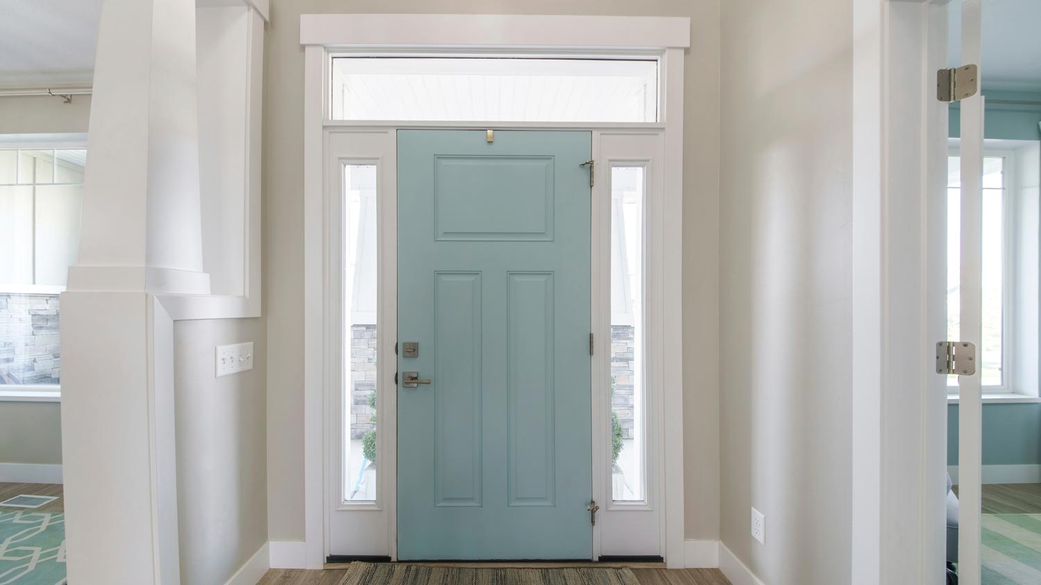 A mint front door with a transom window above it