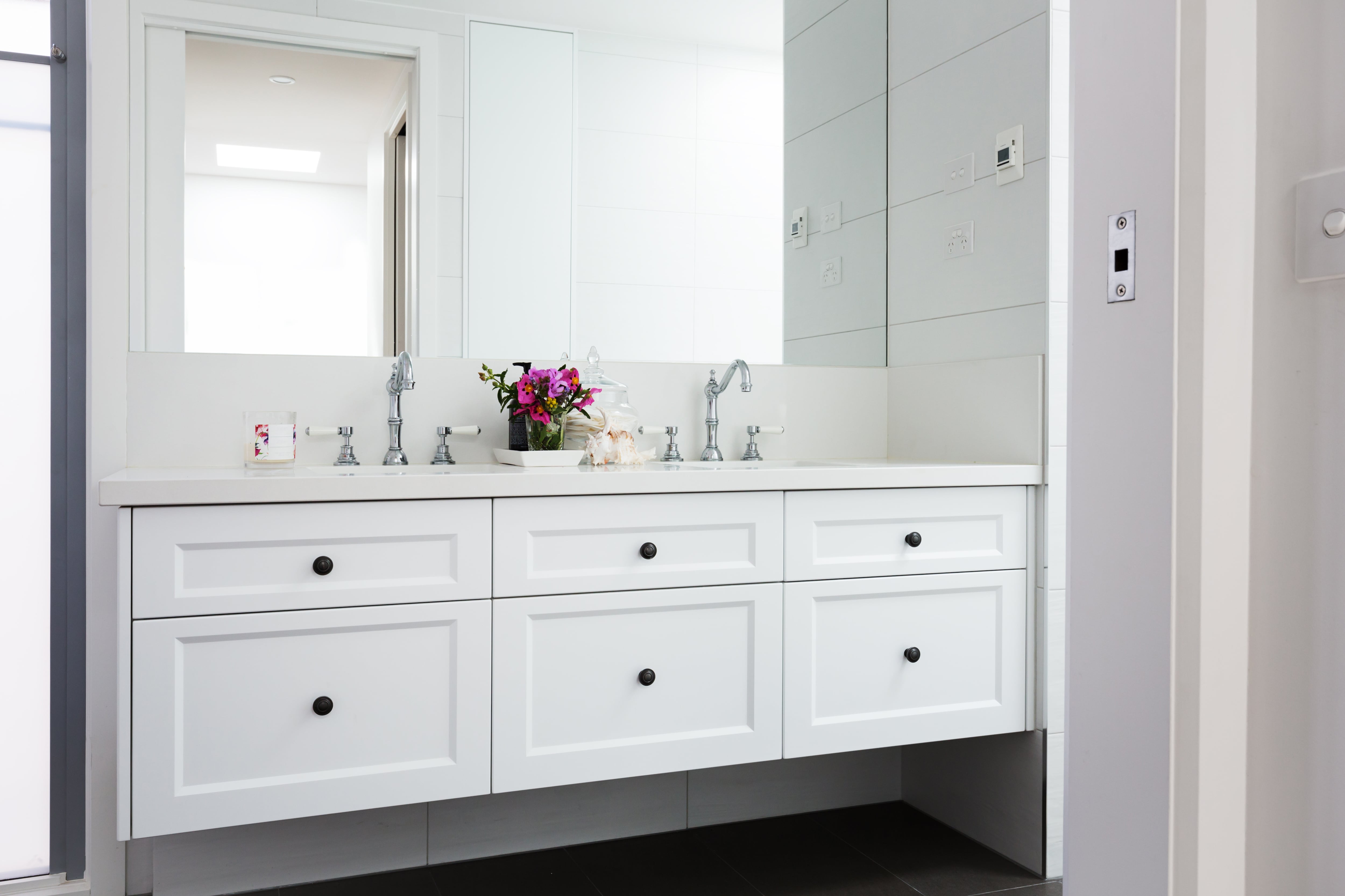 White floating vanity in modern bathroom