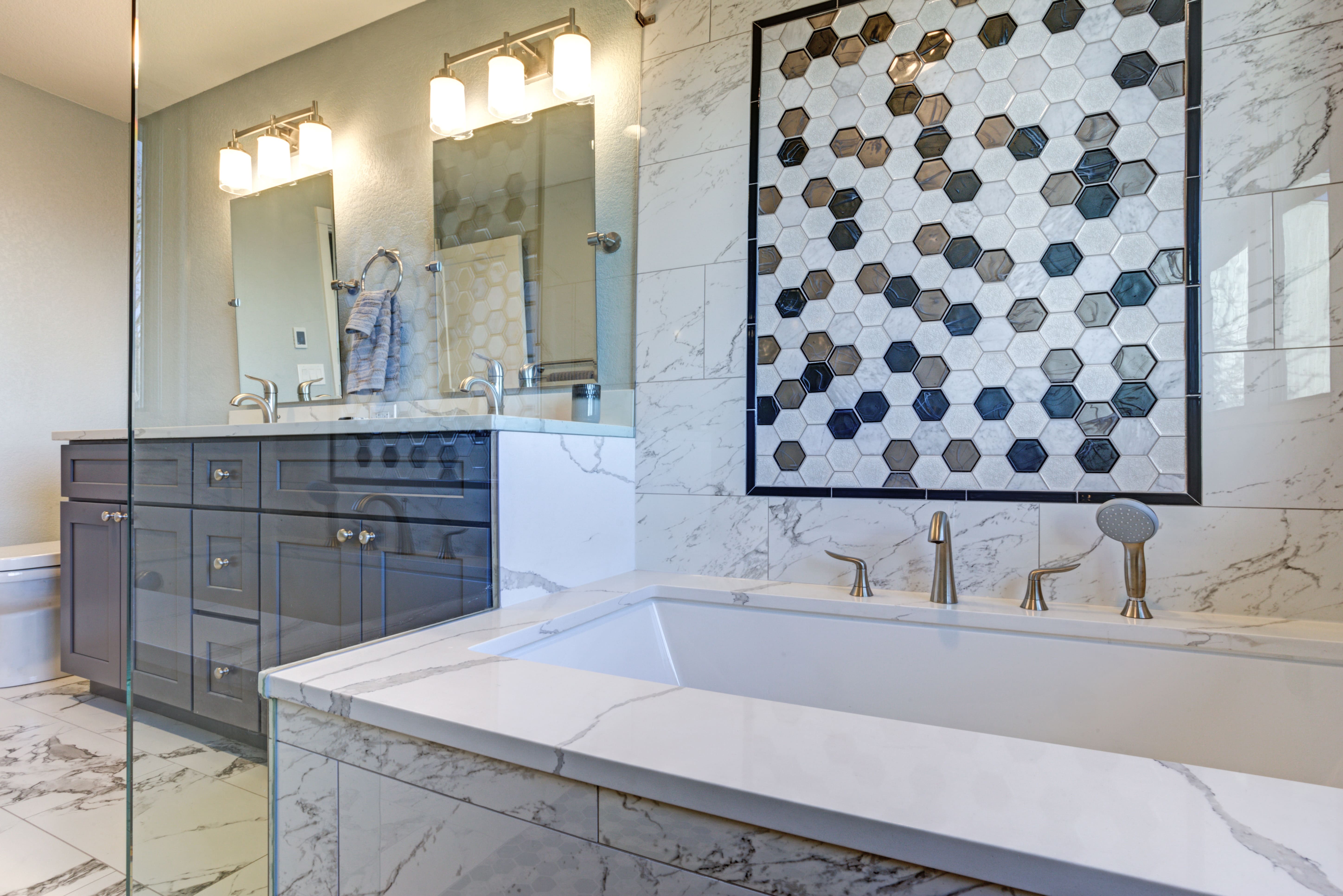 Large luxury bathroom with mosaic tiling