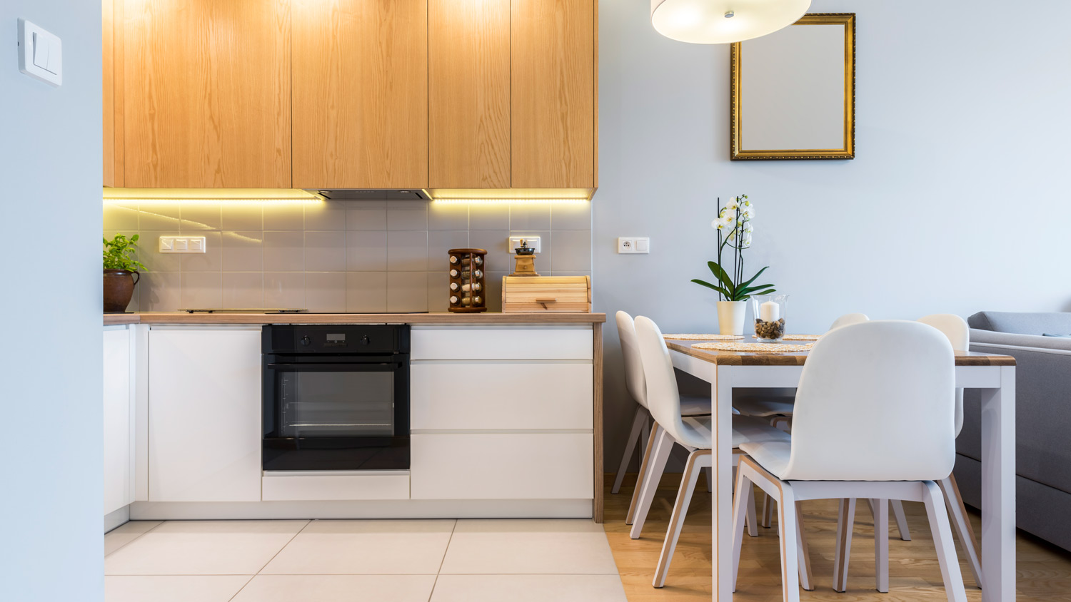 A modern kitchen with wooden and white cabinets