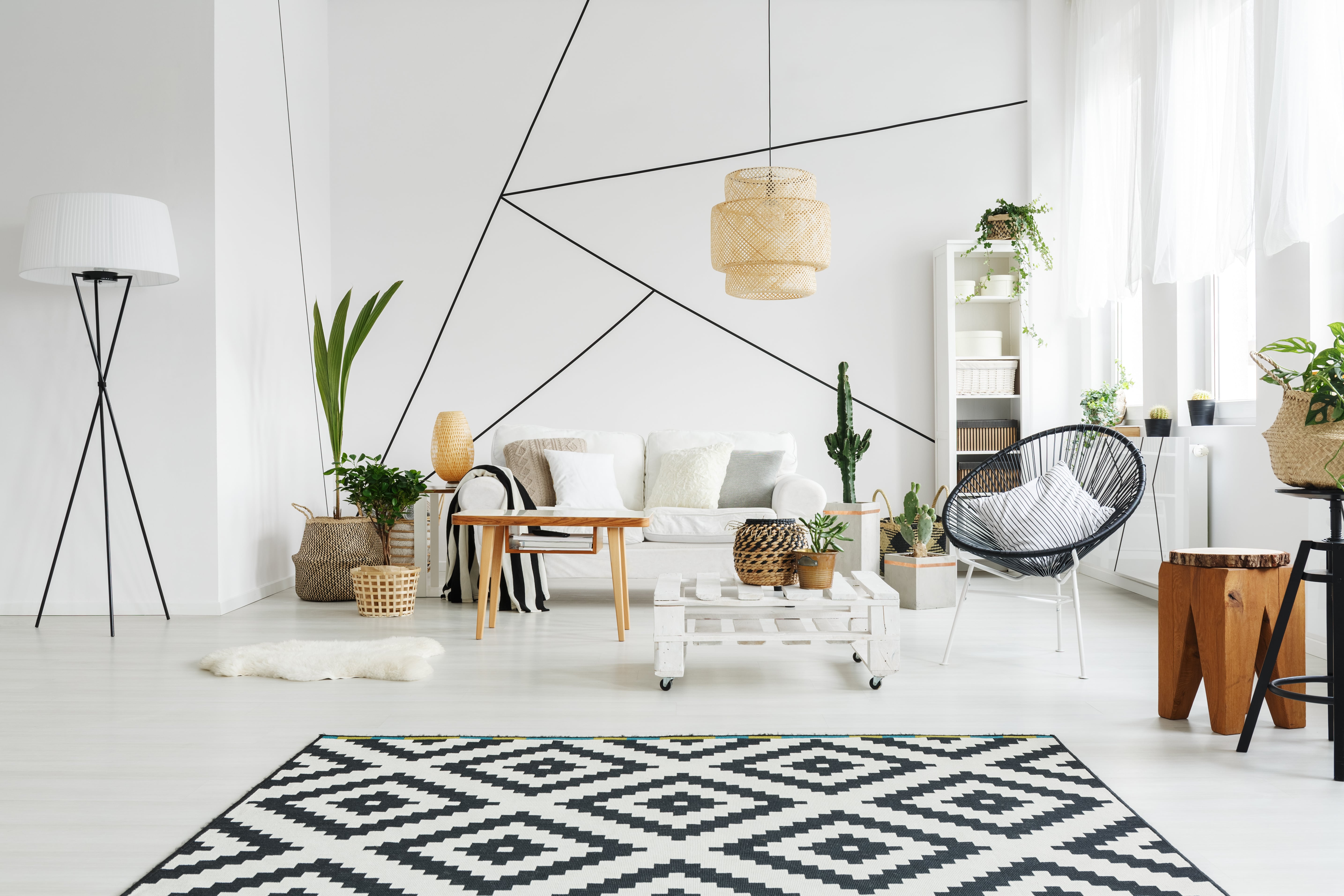 A black-and-white themed living room with a geometric accent wall