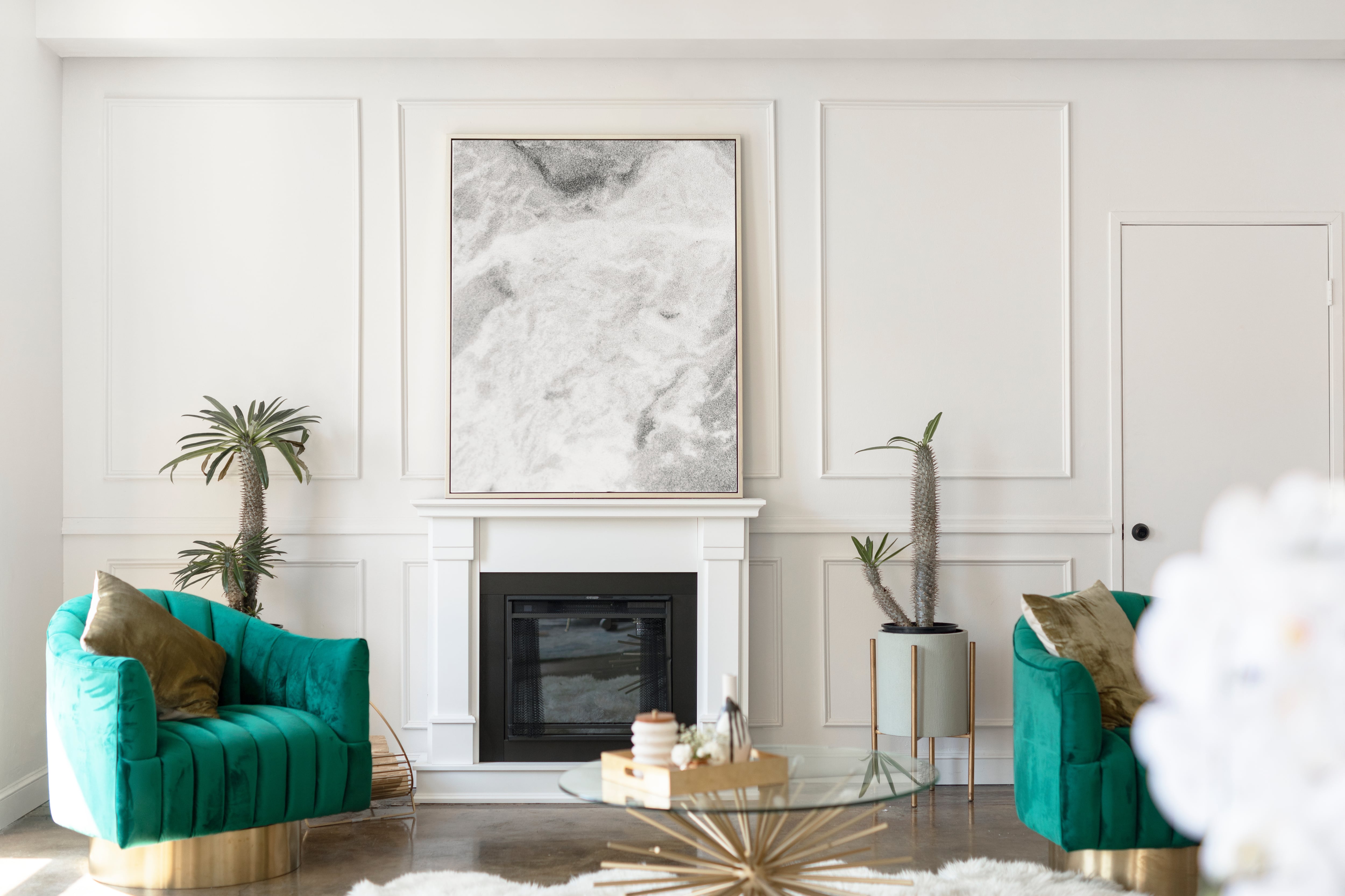 An upscale living room with Art Deco influences and gold accents