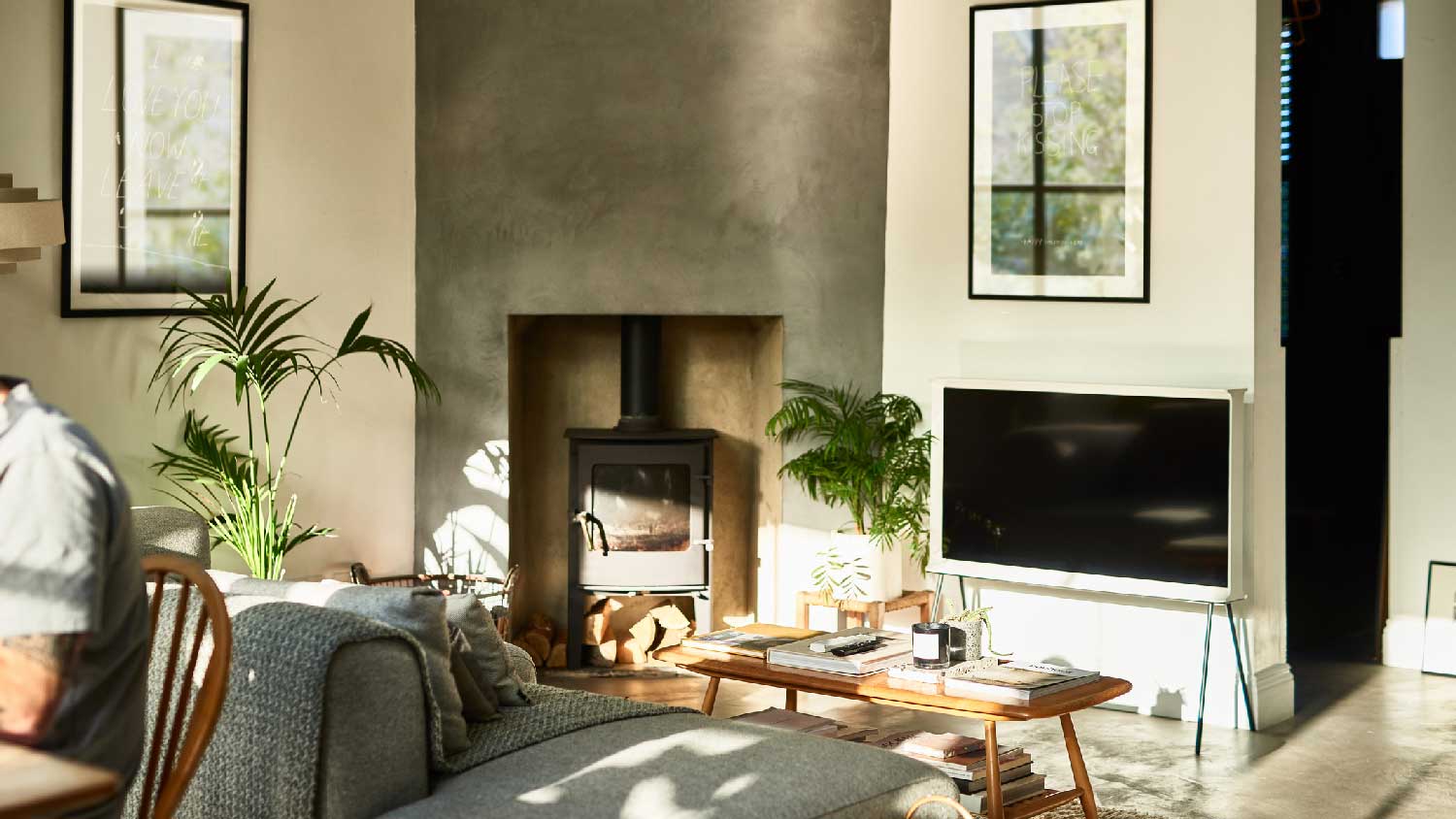 A modern lounge with a fireplace and natural sunlight on the walls