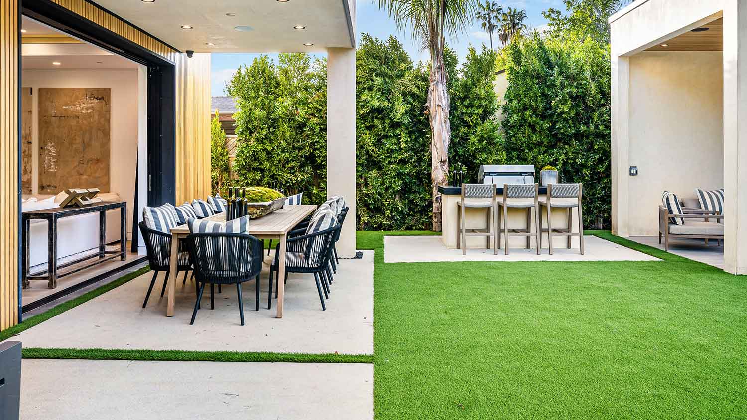 Modern concrete dining area with a grill