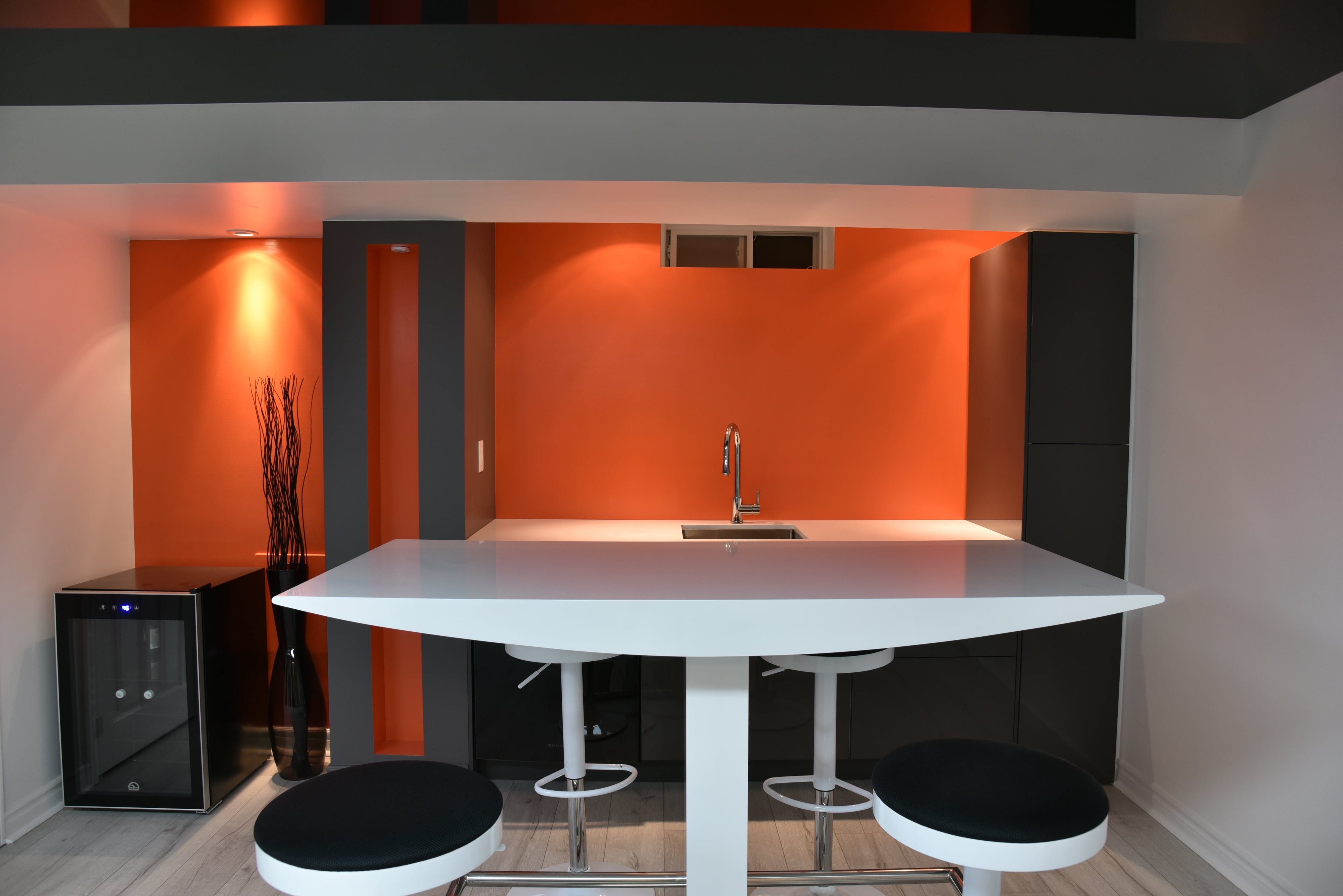 Modern bar in basement with red accent wall
