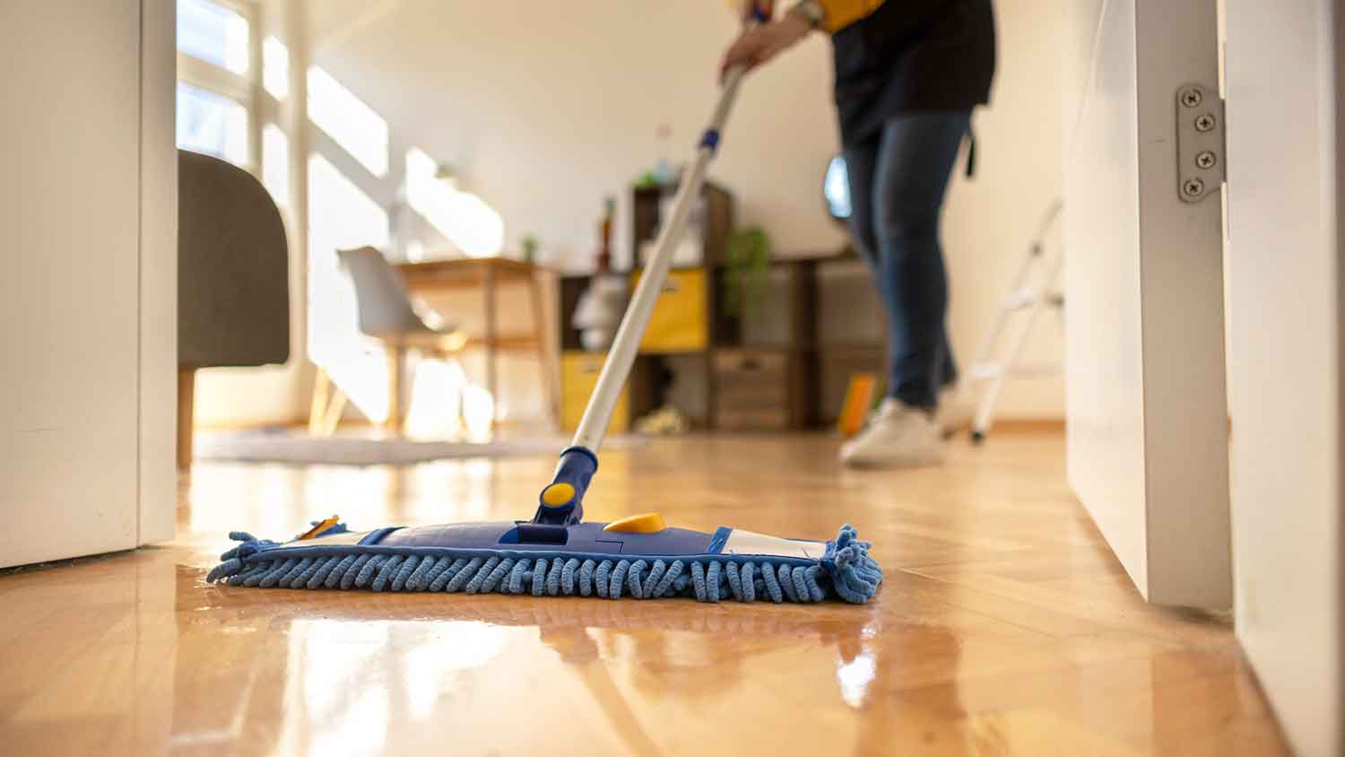 Closeup of a person mopping the bedroom floor