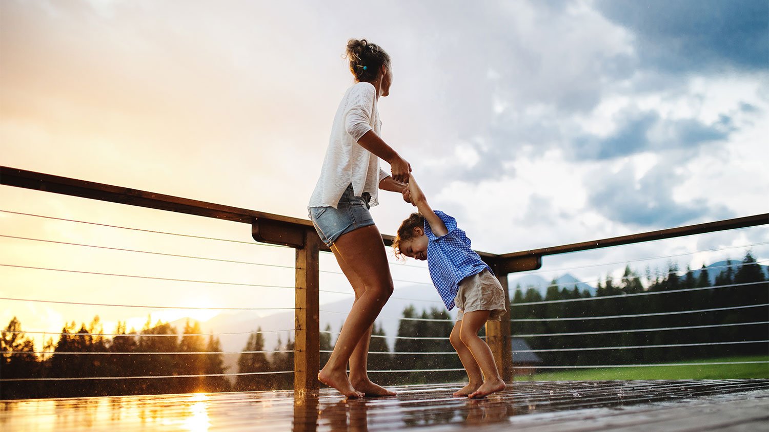 A mother and son play on a deck