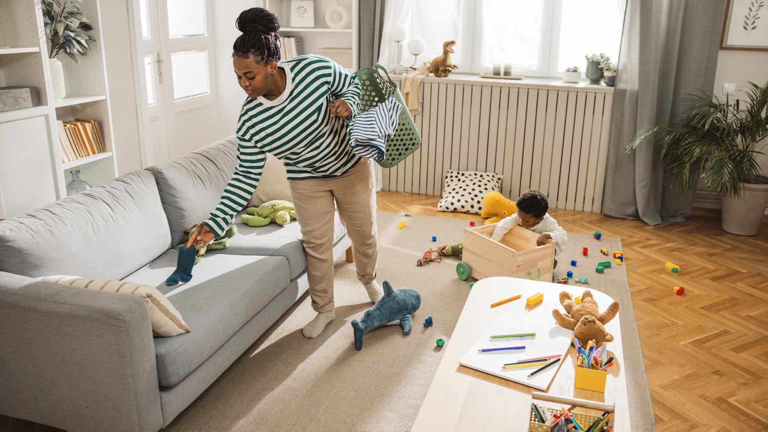 mother tidying up living room