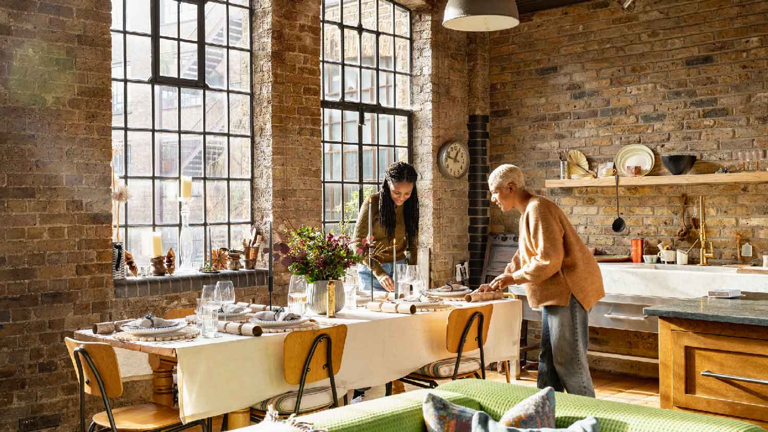 A mother and a daughter setting the table