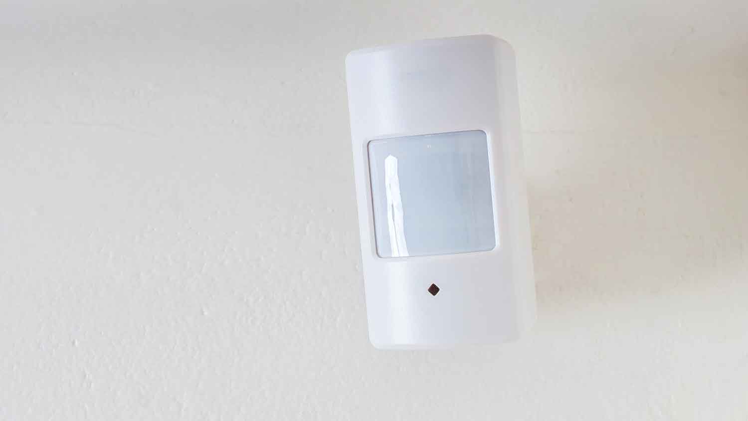 Security system motion sensor mounted on the wall