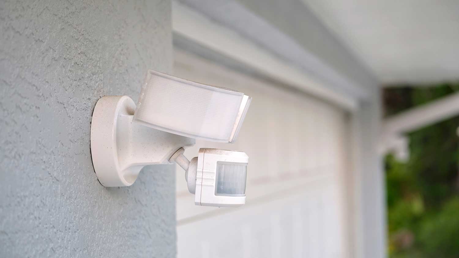 Motion sensor security light installed by the garage door