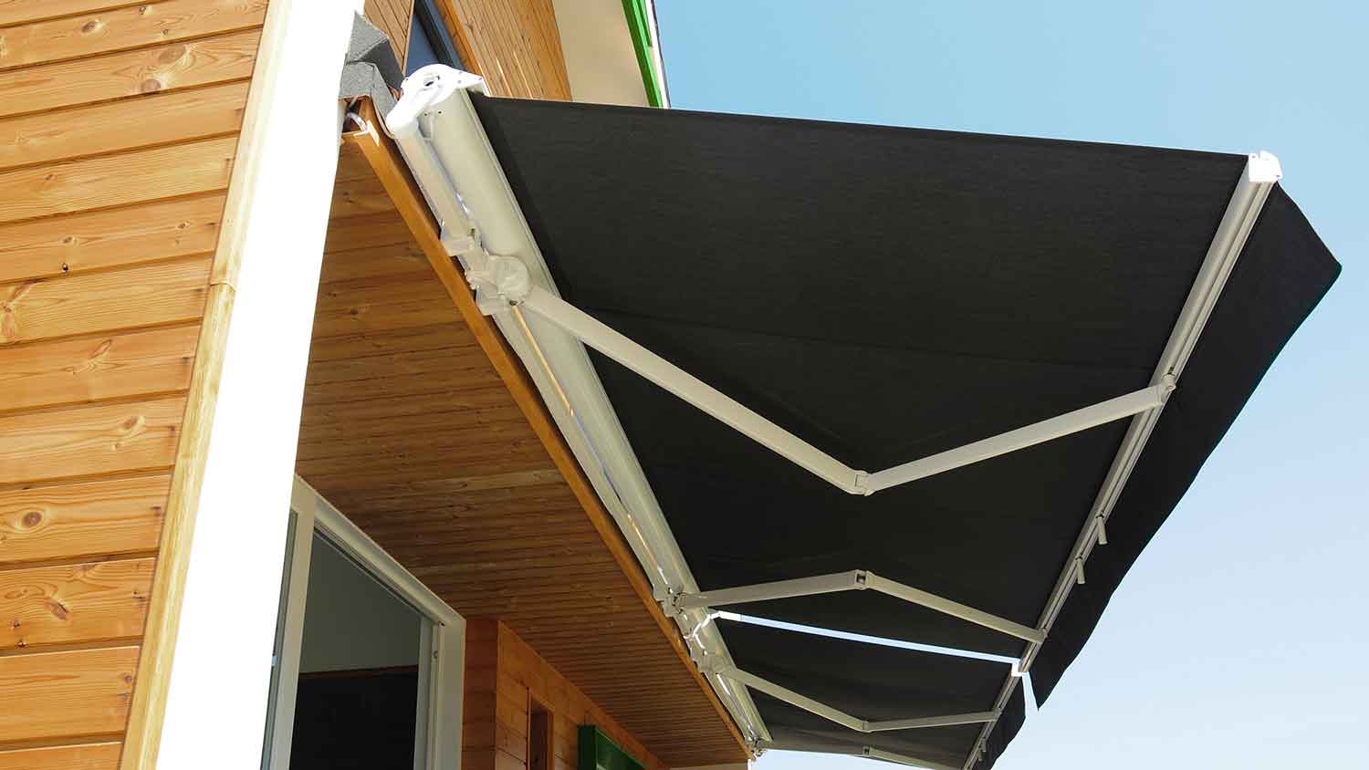 Motorized patio awning installed above the patio door