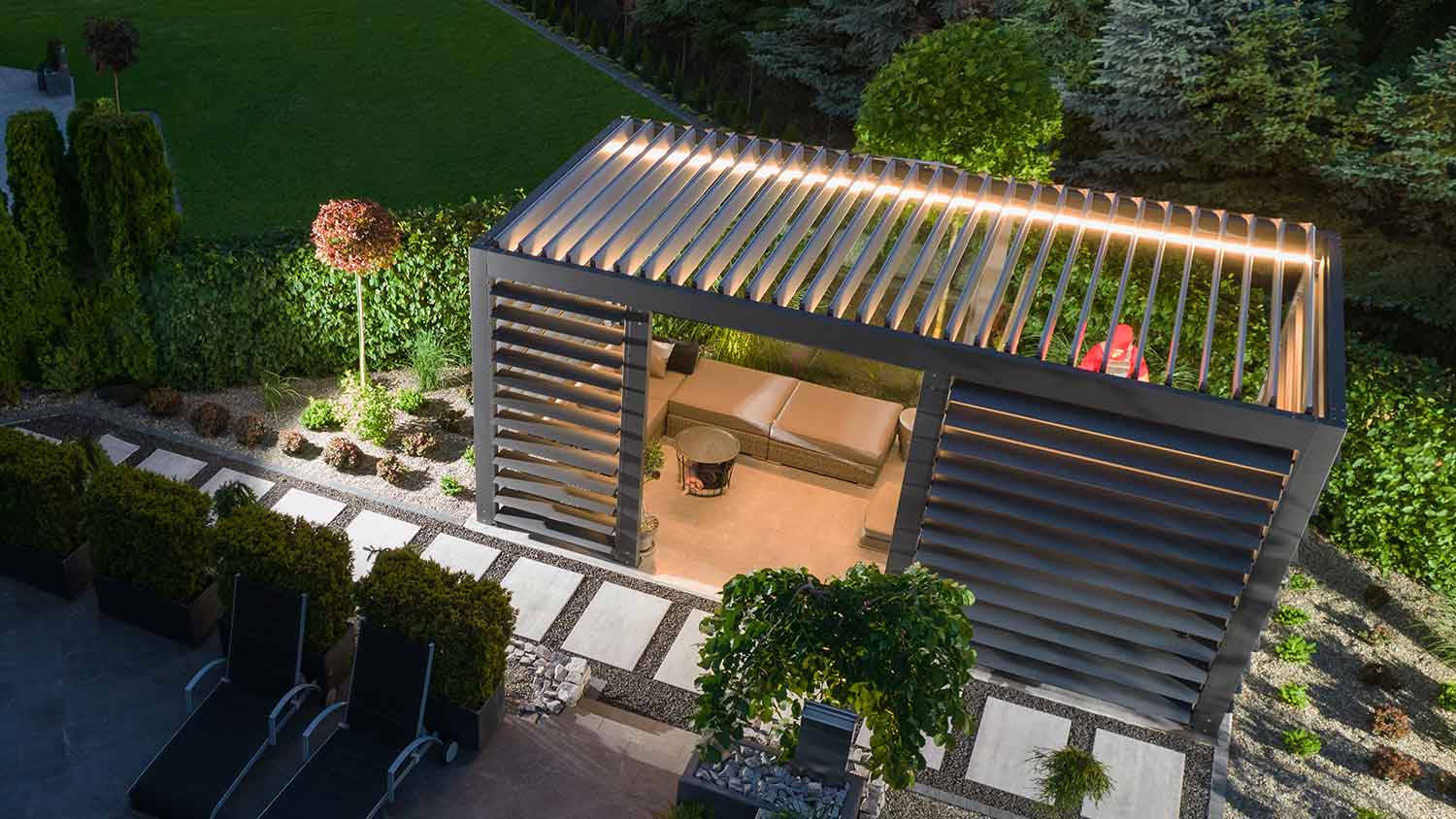 Illuminated pergola with motorized roof and walls