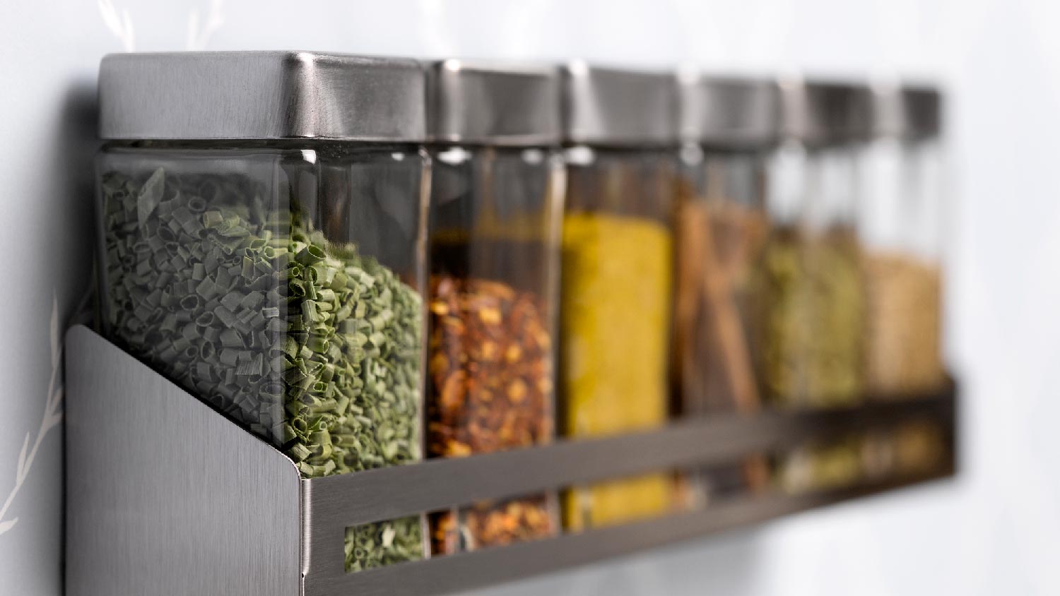 Close-up of a spice rack mounted on the wall