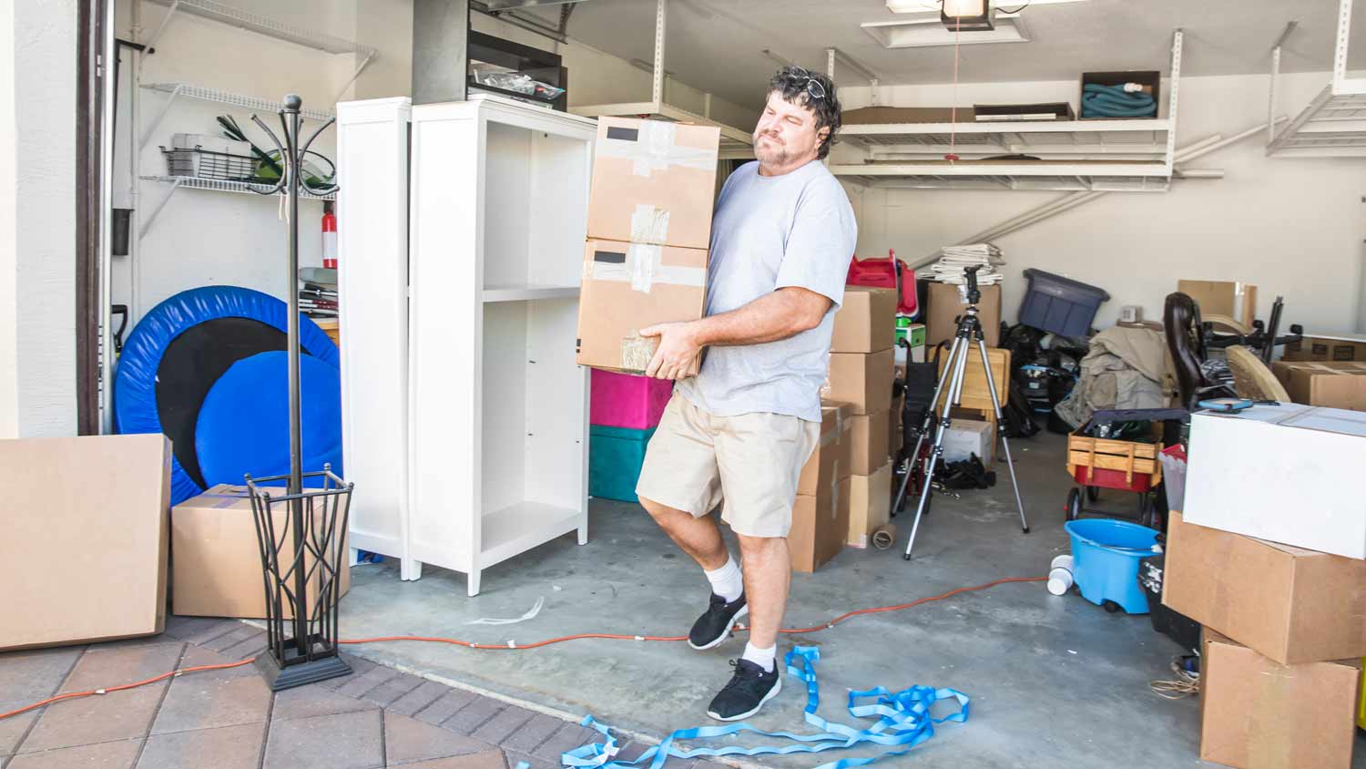 mover carrying boxes from garage