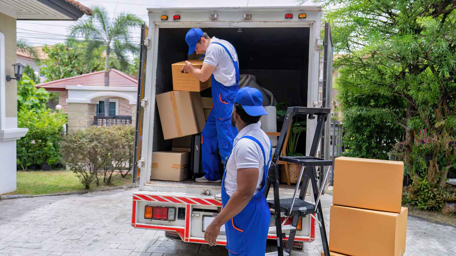 Movers unloading boxes from a truck