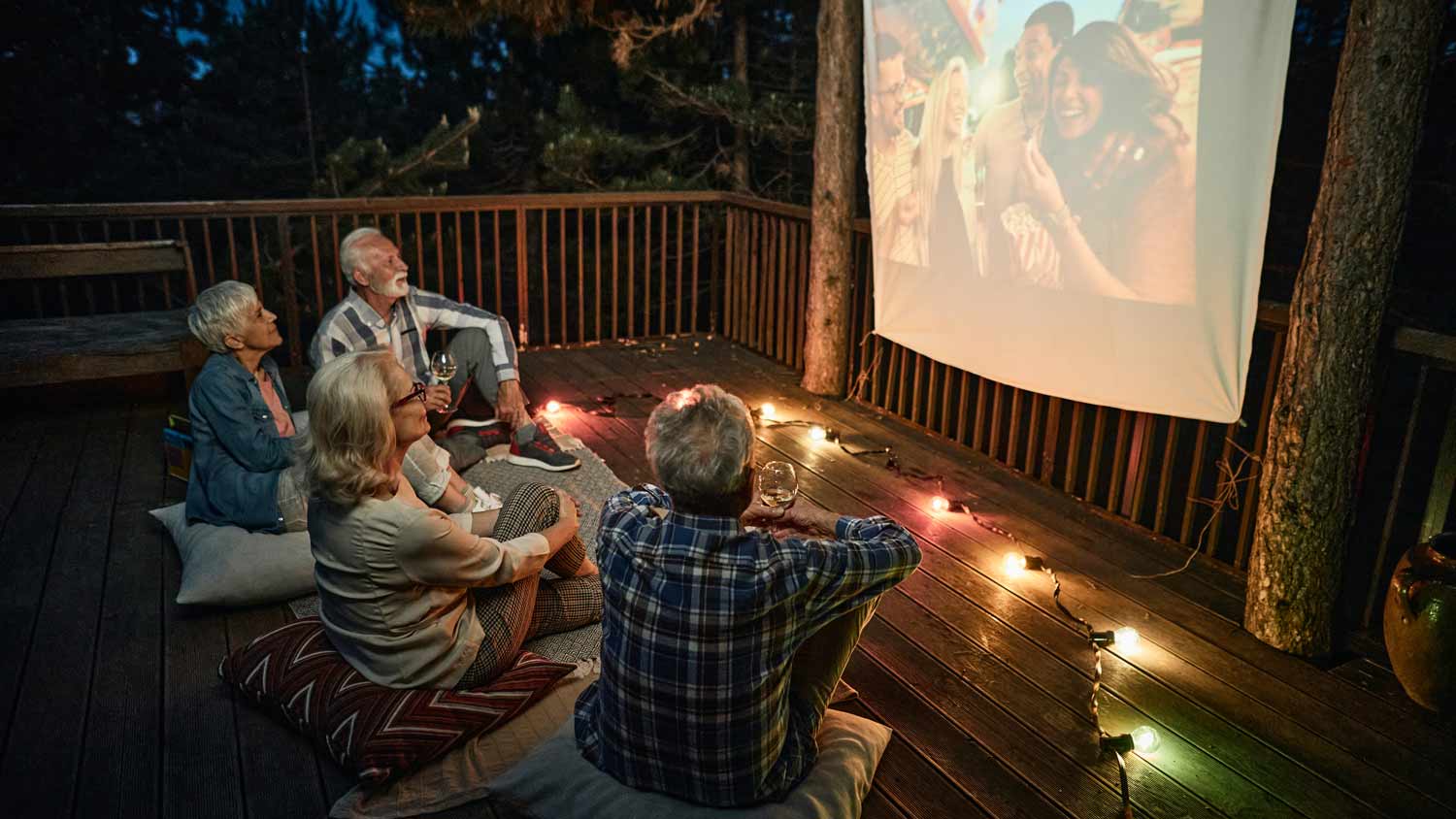 mature couples having movie night on porch