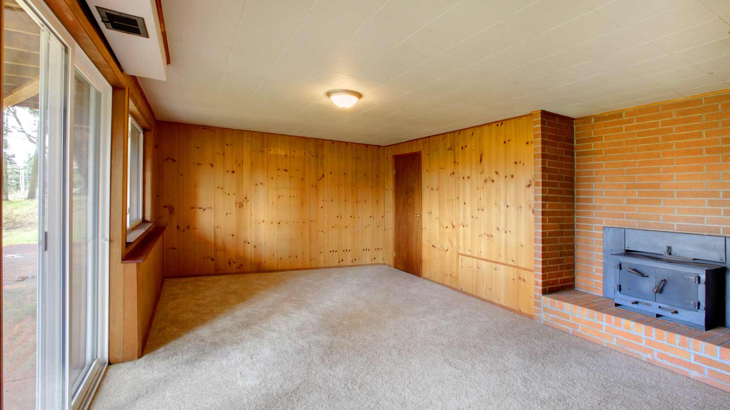 living room with natural wood panels 