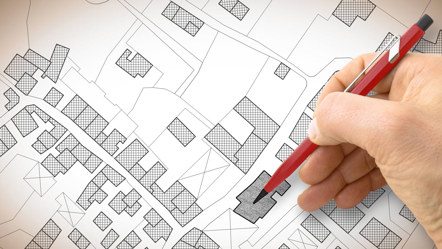 Hand drawing an imaginary cadastral map of territory with buildings and roads