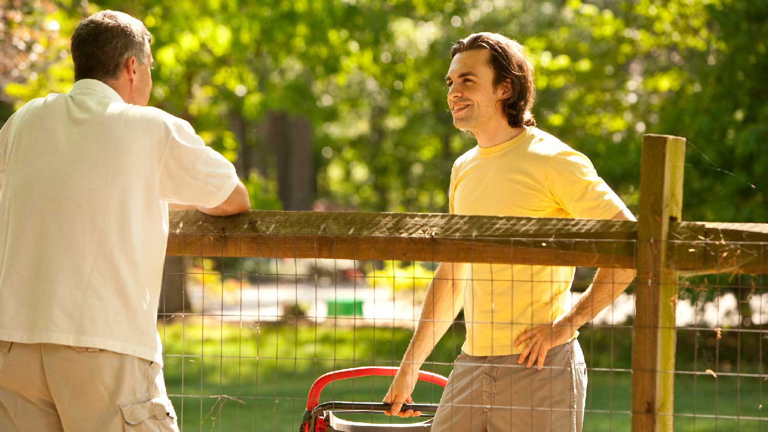 Neighbors talking to each other over the fence