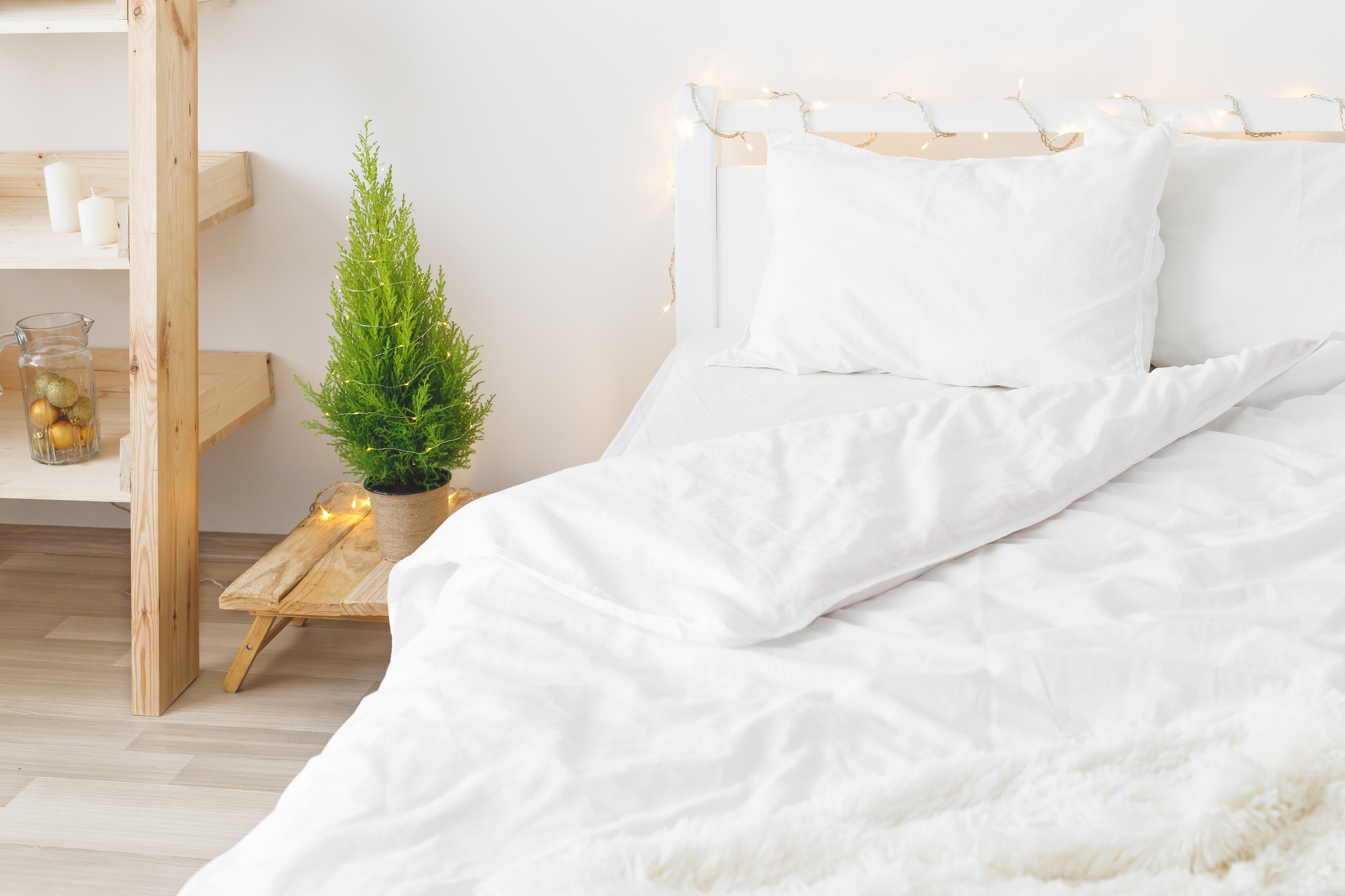 Modern bedroom with light colors and white bedding