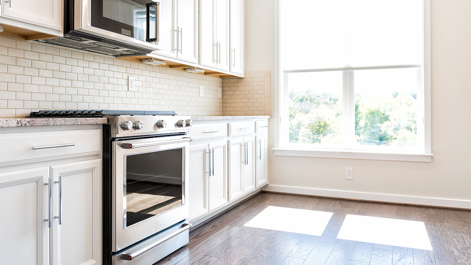 Neutral kitchen with white partial overlay cabinets