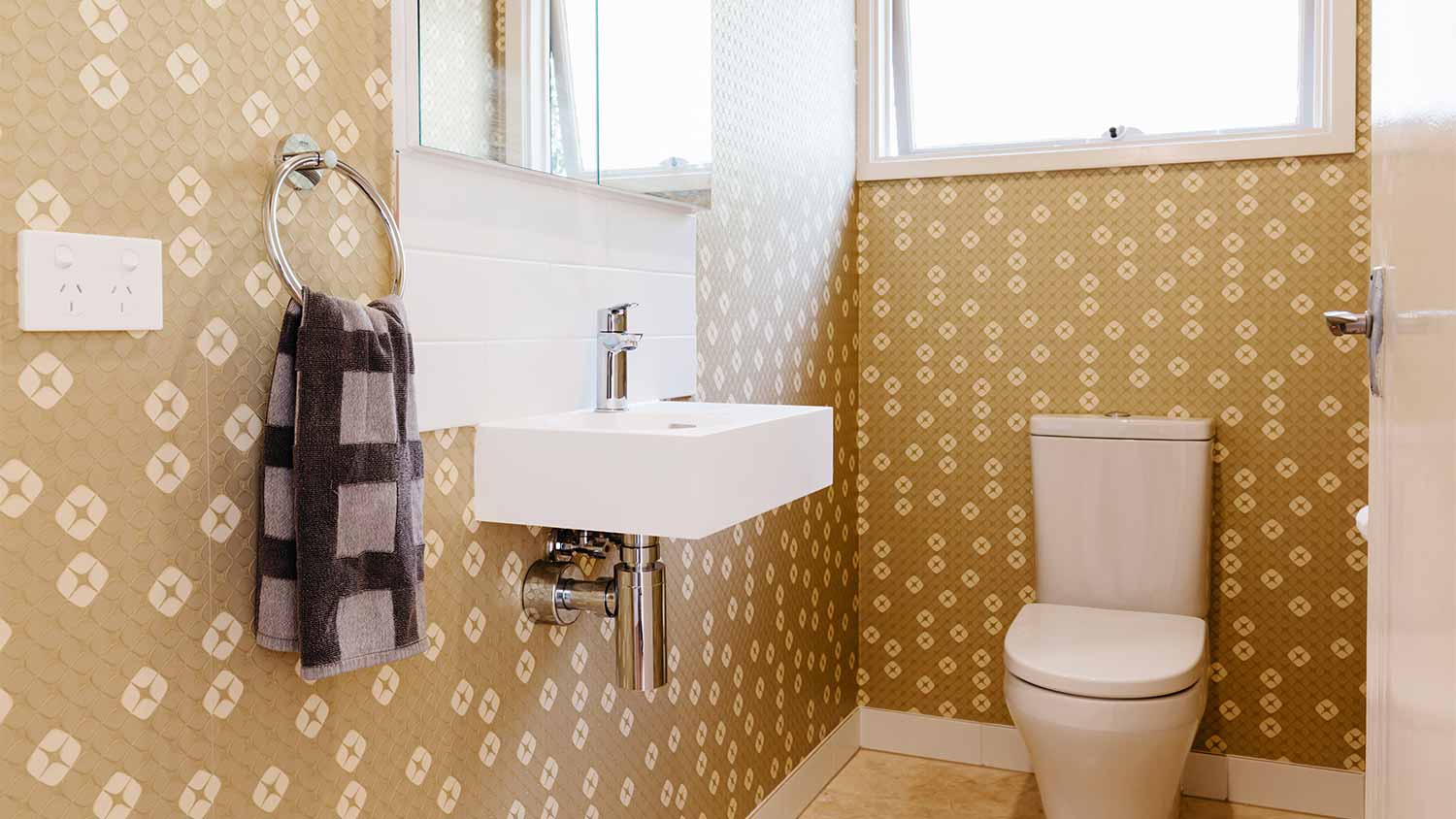 small bathroom with gold wallpaper 