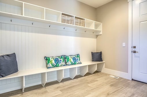 New mudroom with a large bench and cubbyhole storage