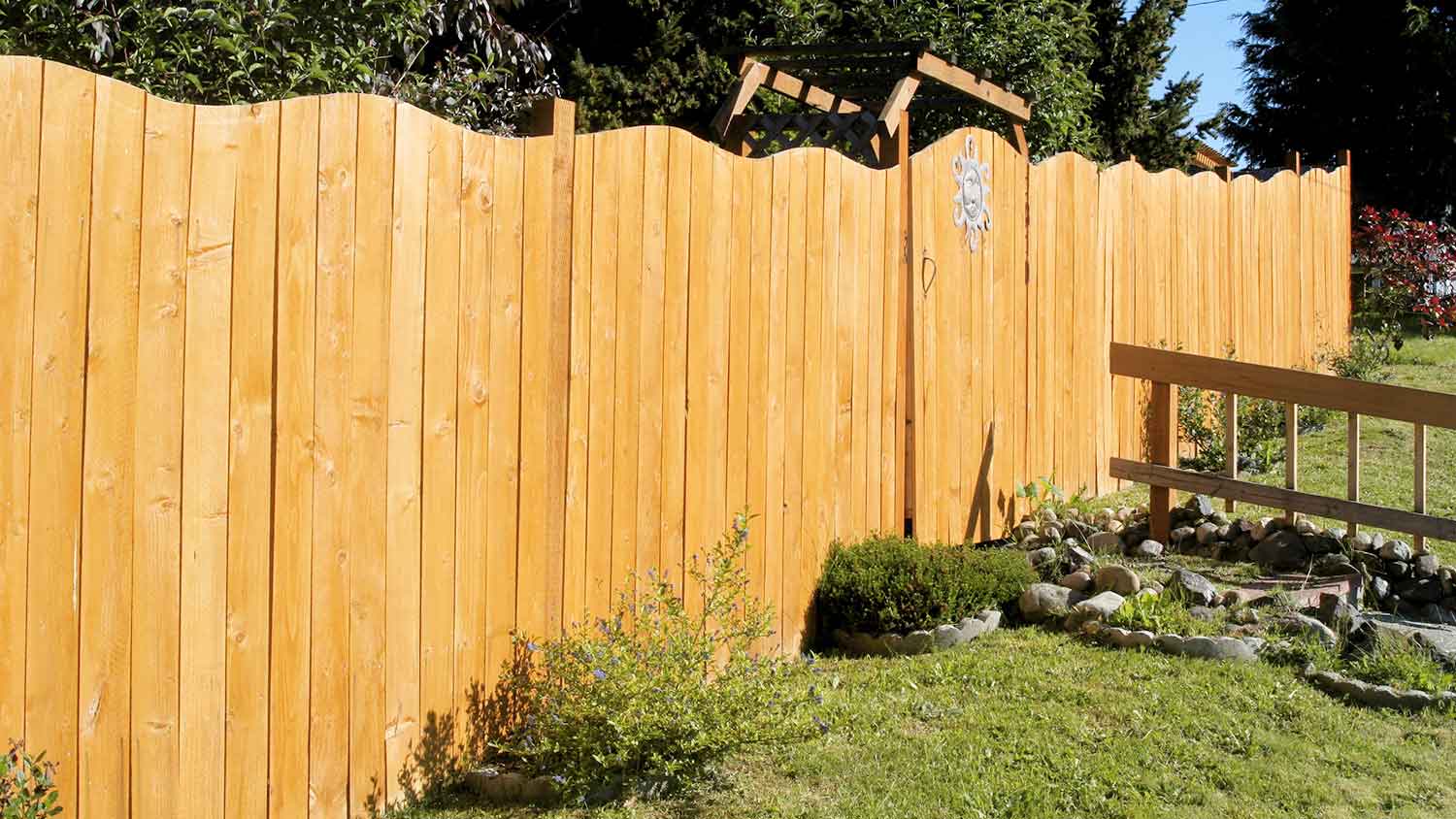 Wavy wood fence installed in the backyard