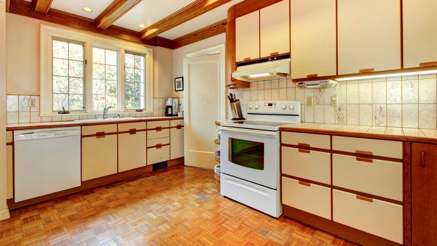 old kitchen with dated floor and cabinets