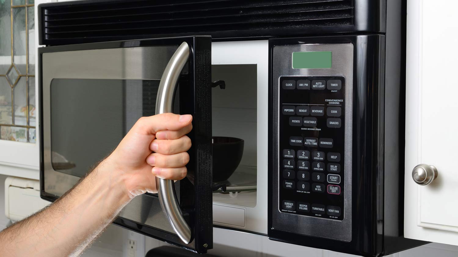 man opening microwave door