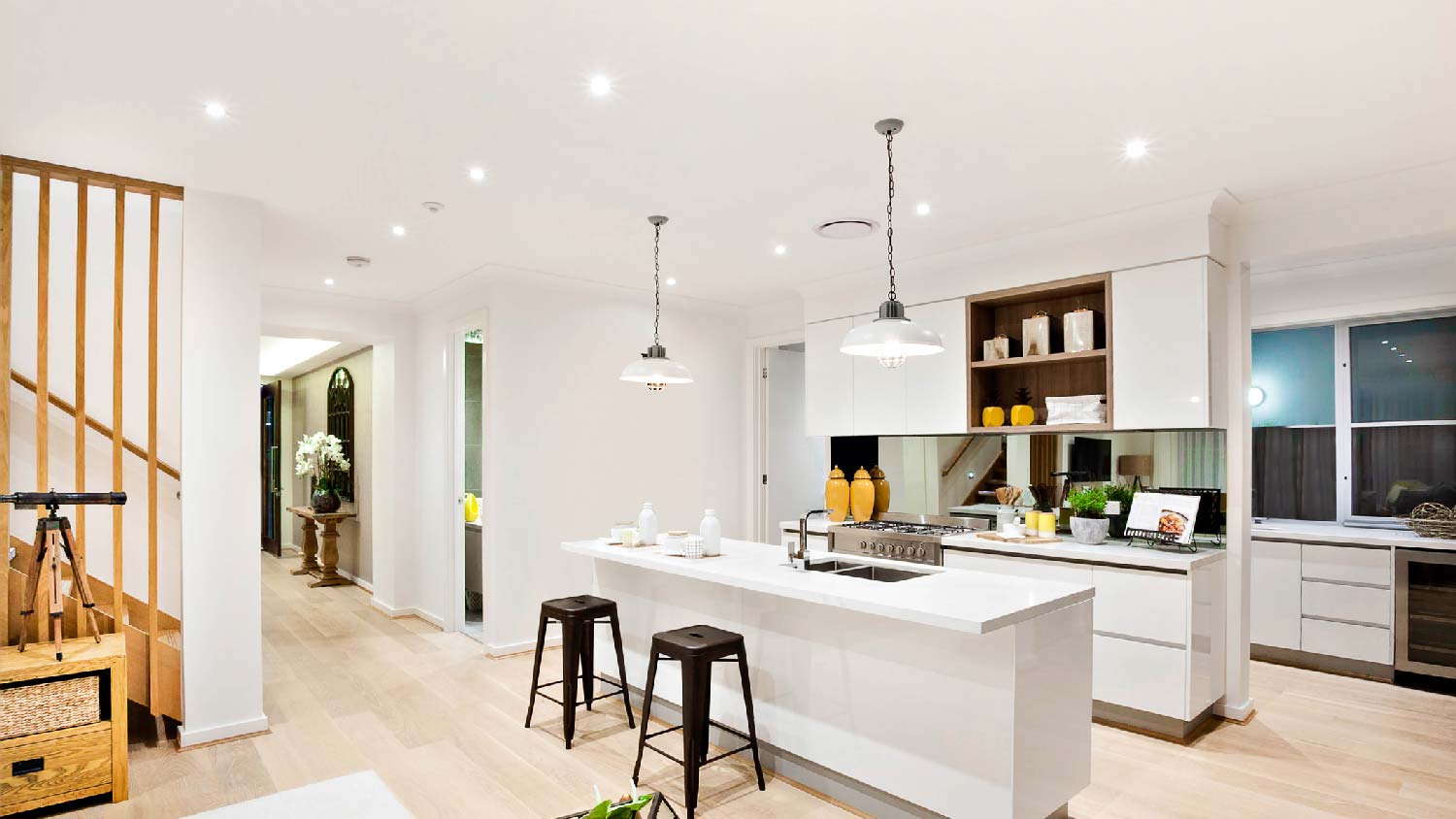 An open space kitchen with recessed lighting having reflector trims