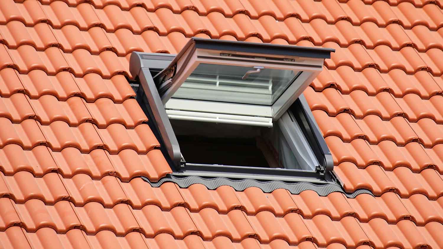 Vented skylight installed in a tile roof
