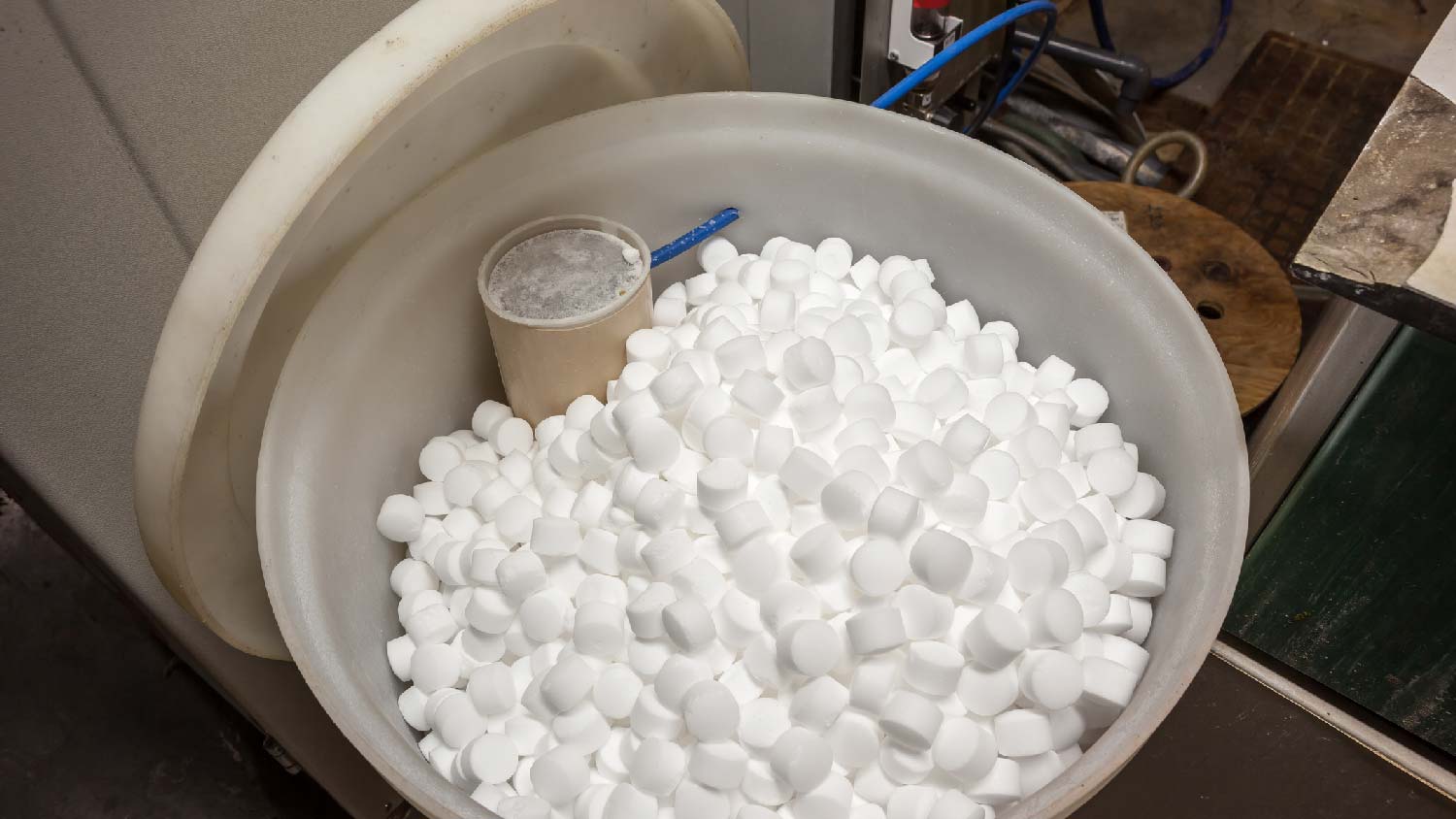An open water softener with salt blocks in it