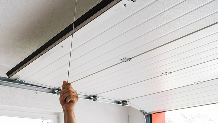 Person opens a garage door manually