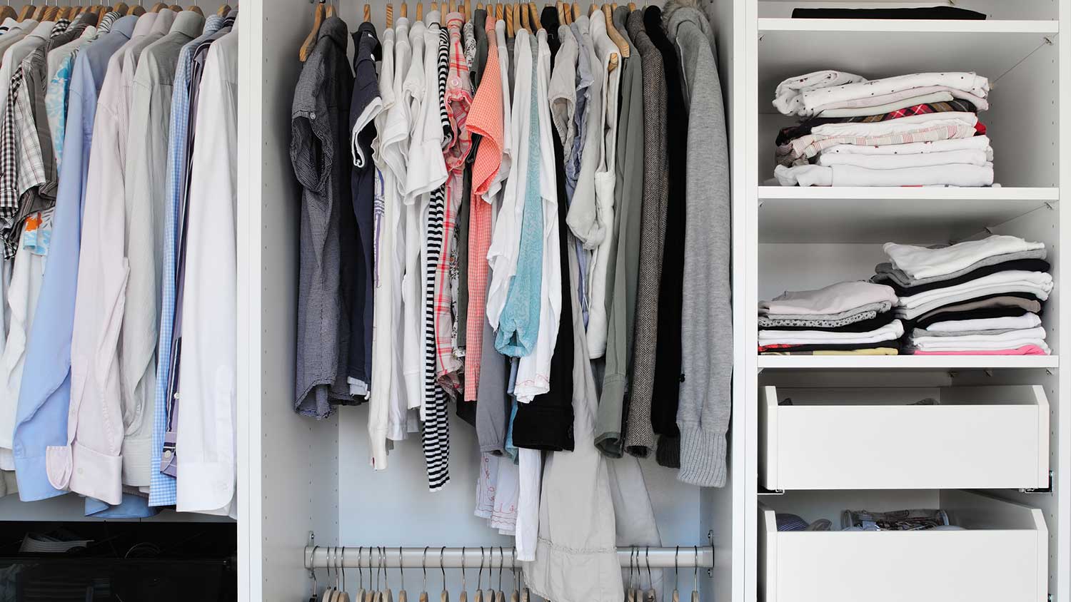 Closet interior with extra clothing rods and white shelves