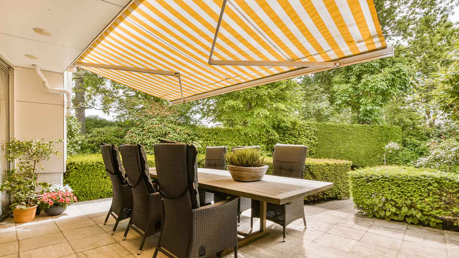 Outdoor dining area with an awning pergola